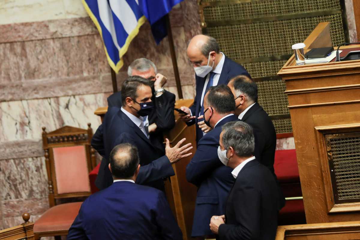Greek Prime Minister Kyriakos Mitsotakis speaks with members of the Hellenic Parliament during a parliamentary session ahead of a vote on a new labour bill, in Athens, Greece, June 16, 2021. REUTERS