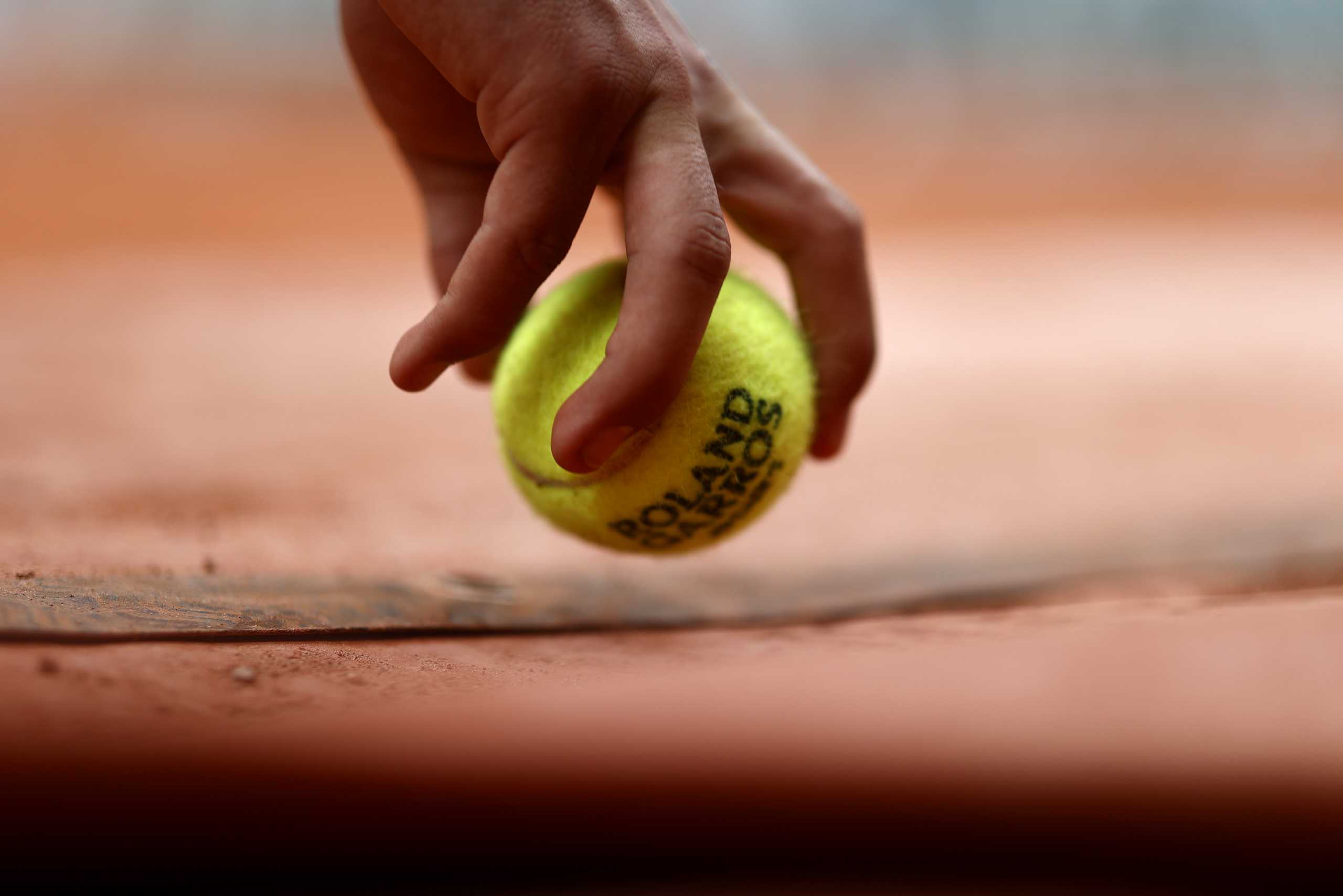 Tennis - French Open - Roland Garros, Paris, France - June 3, 2021 A ball kid picks up a ball during the second round match between Switzerland's Roger Federer and Croatia's Marin Cilic REUTERS