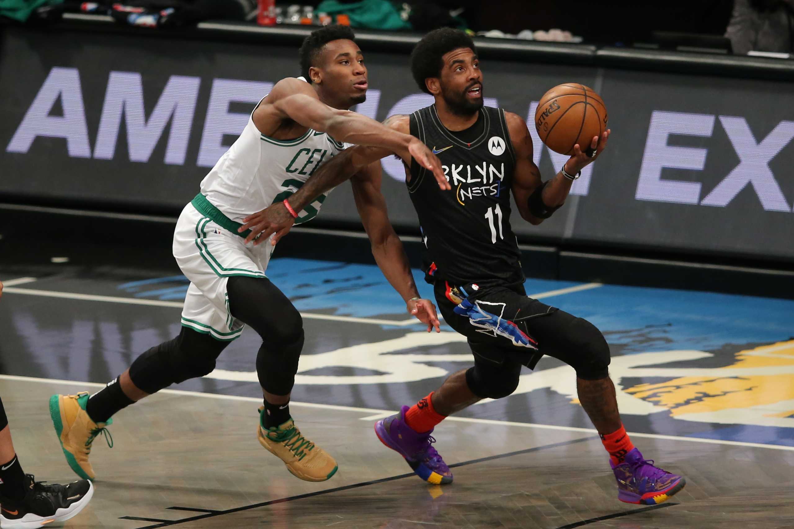 Jun 1, 2021; Brooklyn, New York, USA; Brooklyn Nets point guard Kyrie Irving (11) drives to the basket against Boston Celtics small forward Aaron Nesmith (26) during the first quarter of game five of the first round of the 2021 NBA Playoffs at Barclays Center. Mandatory Credit: Brad Penner-USA TODAY Sports