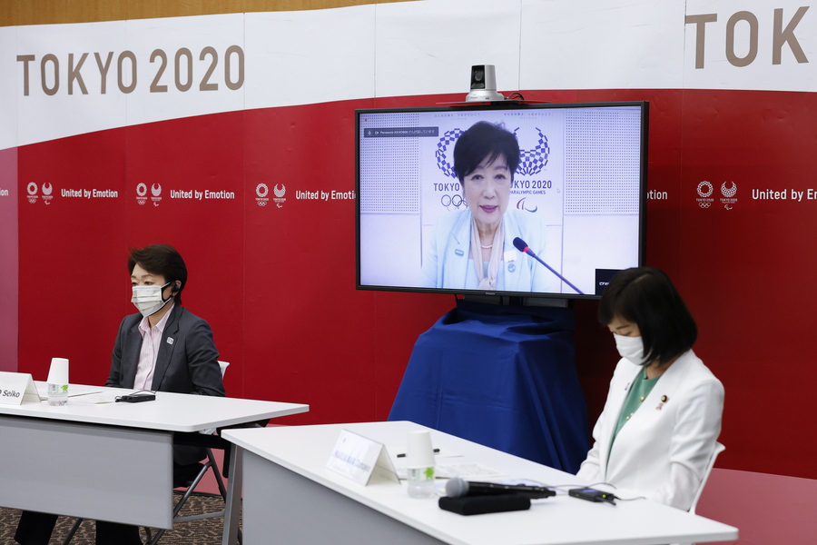 epa09290034 (L-R) President of Tokyo 2020 Seiko Hashimoto, Tokyo Governor Yuriko Koike (on screen) and Minister for the Tokyo Olympic and Paralympic Games, Tamayo Marukawa speak during a five-party meeting at Harumi Island Triton Square Tower Y in Tokyo, Japan, 21 June 2021. President Hashimoto and Minister Tamayo spoke via teleconference with Thomas Bach President of the International Olympic Committee (IOC), Andrew Parson President of the International Paralympic Committee (IPC) and Tokyo Governor Yuriko Koike.  EPA