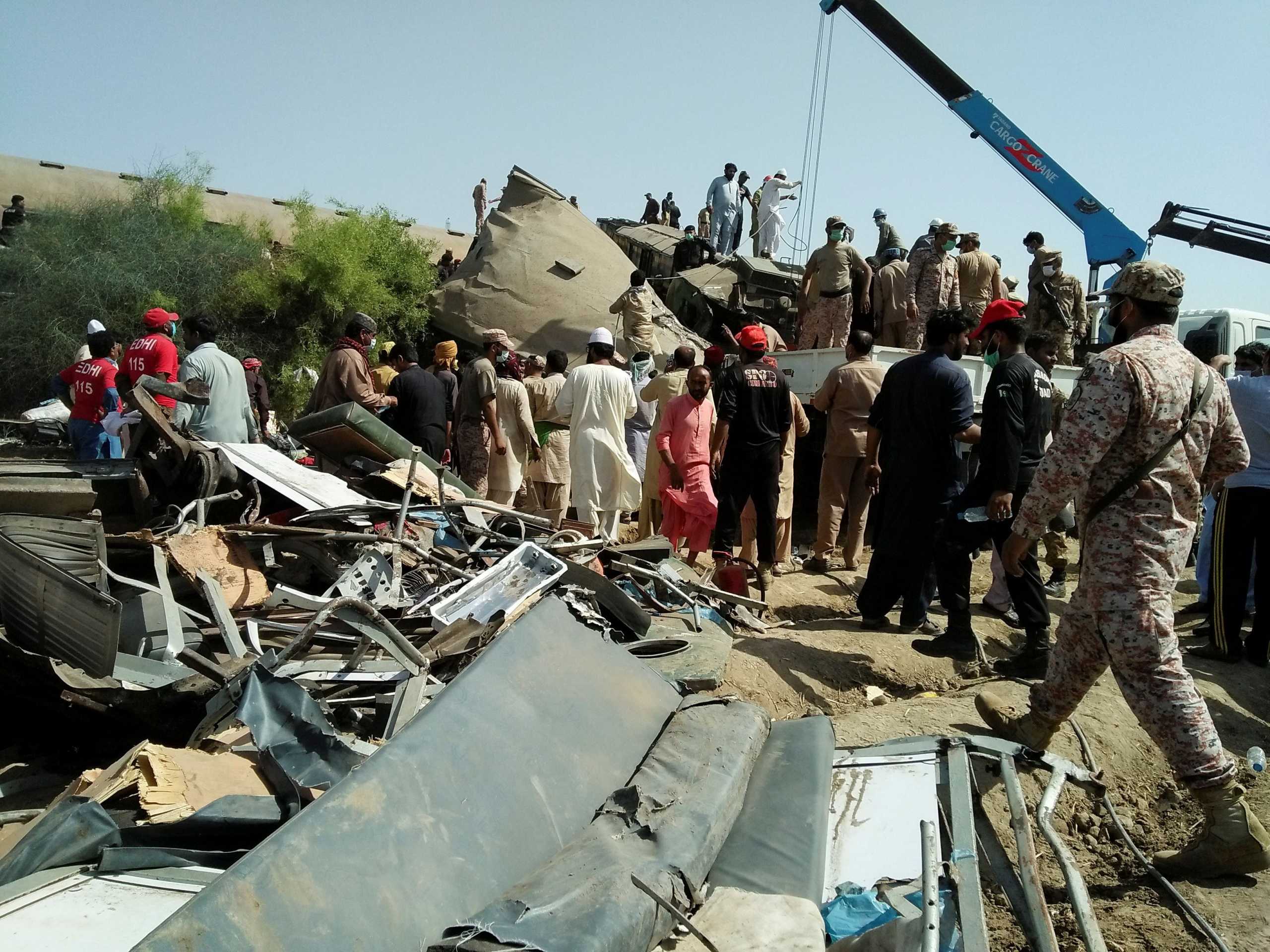 Paramilitary soldiers and rescue workers gather at the site following a collision between two trains in Ghotki, Pakistan June 7, 2021. REUTERS
