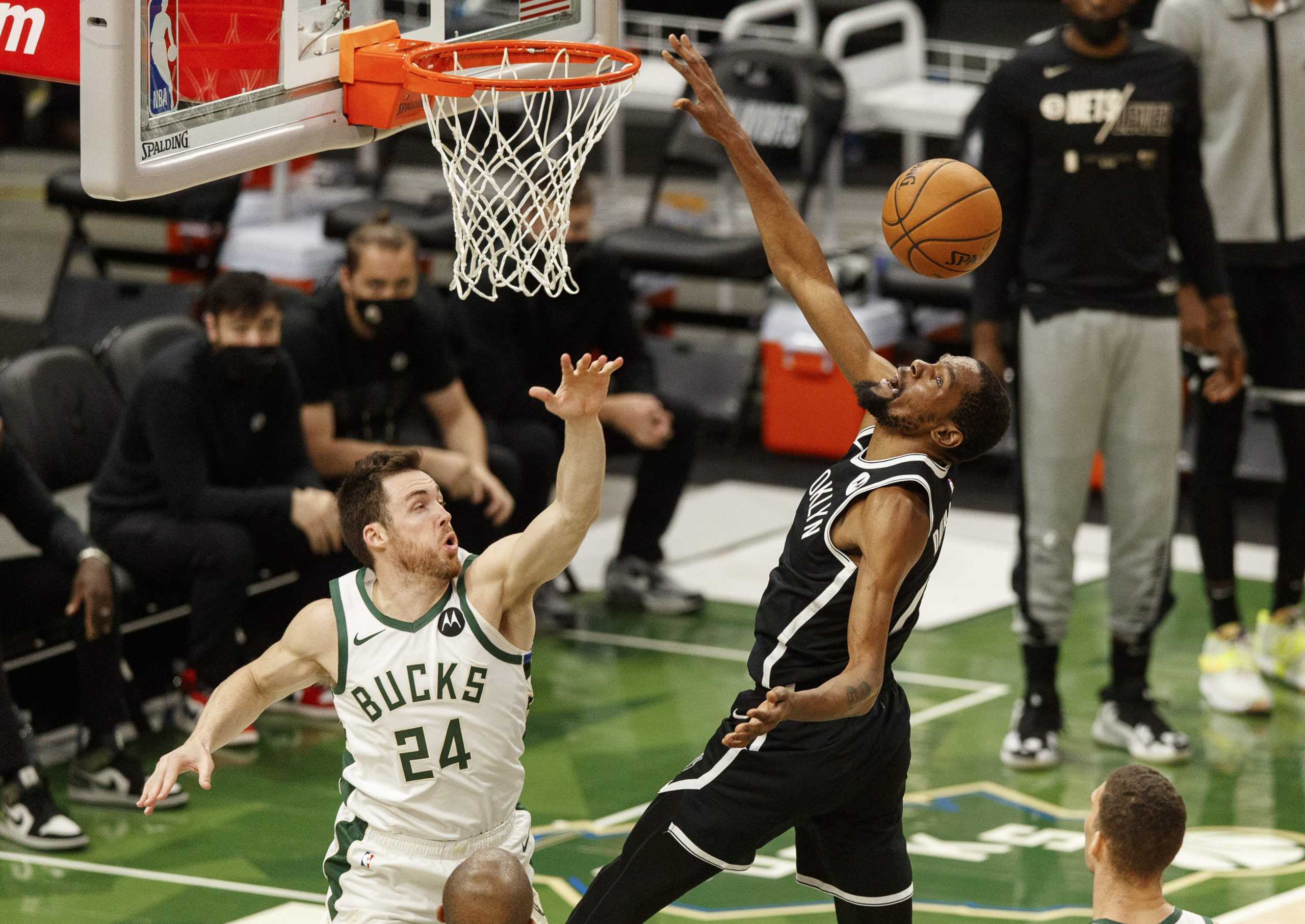 Jun 13, 2021; Milwaukee, Wisconsin, USA;  Brooklyn Nets forward Kevin Durant (7) loses the ball while shooting against Milwaukee Bucks guard Pat Connaughton (24) during the second quarter during game four in the second round of the 2021 NBA Playoffs. at Fiserv Forum. Mandatory Credit: Jeff Hanisch-USA TODAY Sports