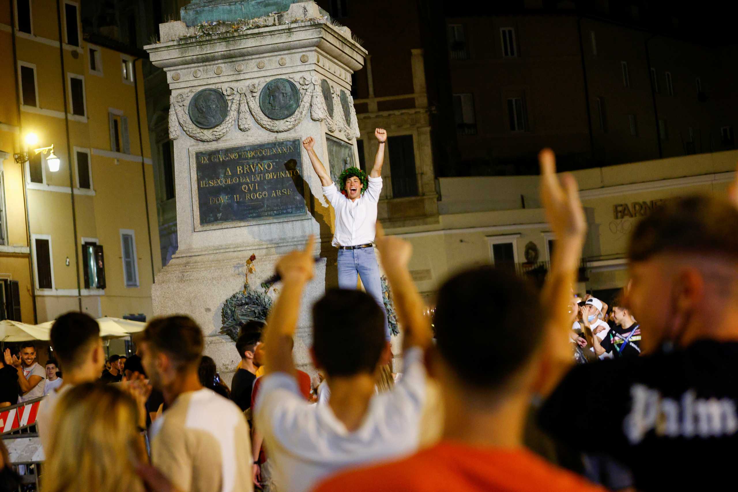 People gather in Campo de' Fiori as much of Italy becomes a low risk "white zone" ditching curfew for the first time in months, in Rome, Italy, June 15, 2021. REUTERS