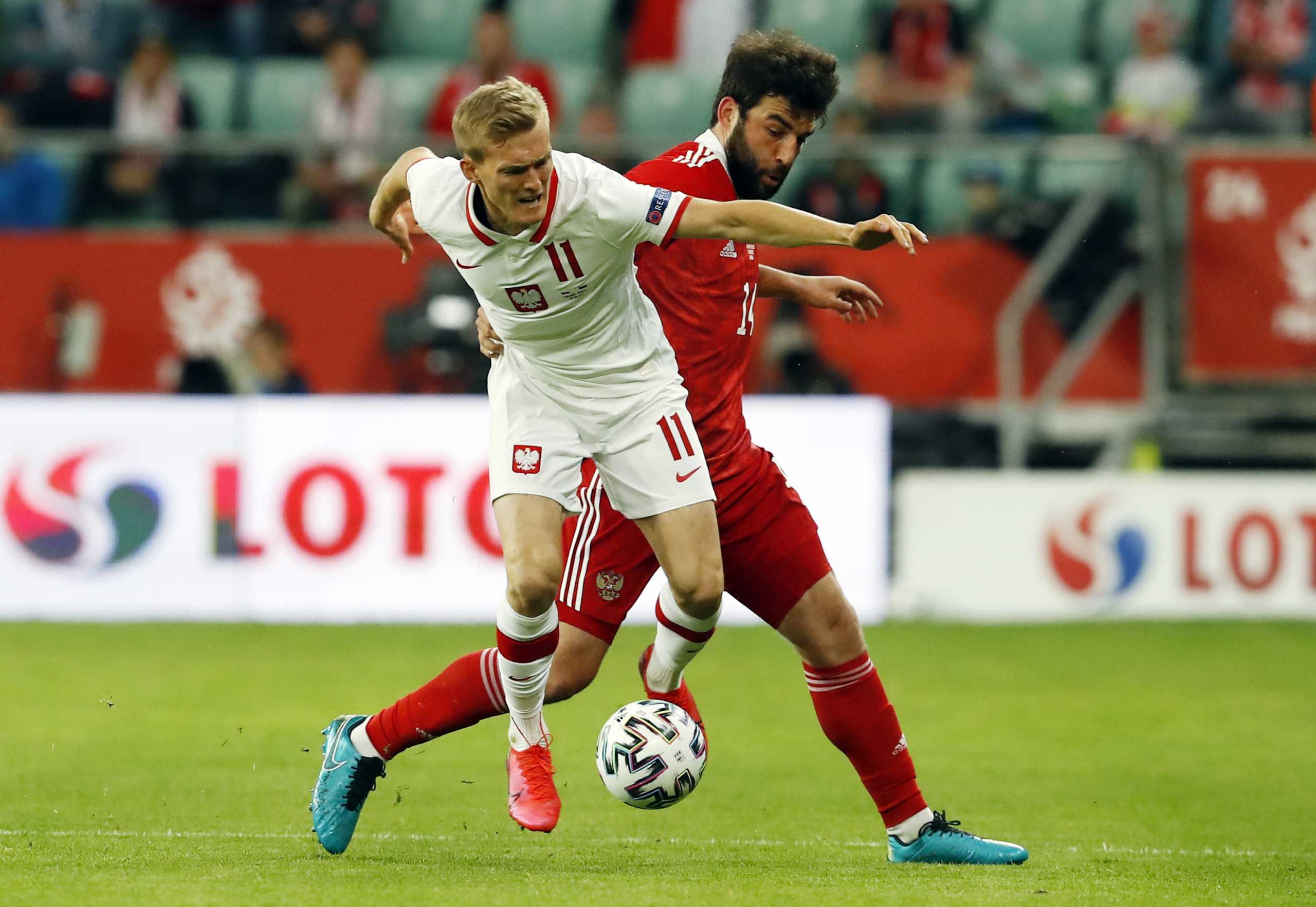 Soccer Football - International Friendly - Poland v Russia - Stadion Miejski, Wroclaw, Poland - June 1, 2021 Poland's Karol Swiderski in action with Russia's Giorgi Jikia REUTERS