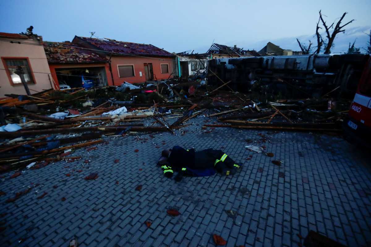 A member of the emergency services rests amid the debris caused by a rare tornado that struck and destroyed parts of some towns, in the village of Moravska Nova Ves, Czech Republic, June 25, 2021. REUTERS