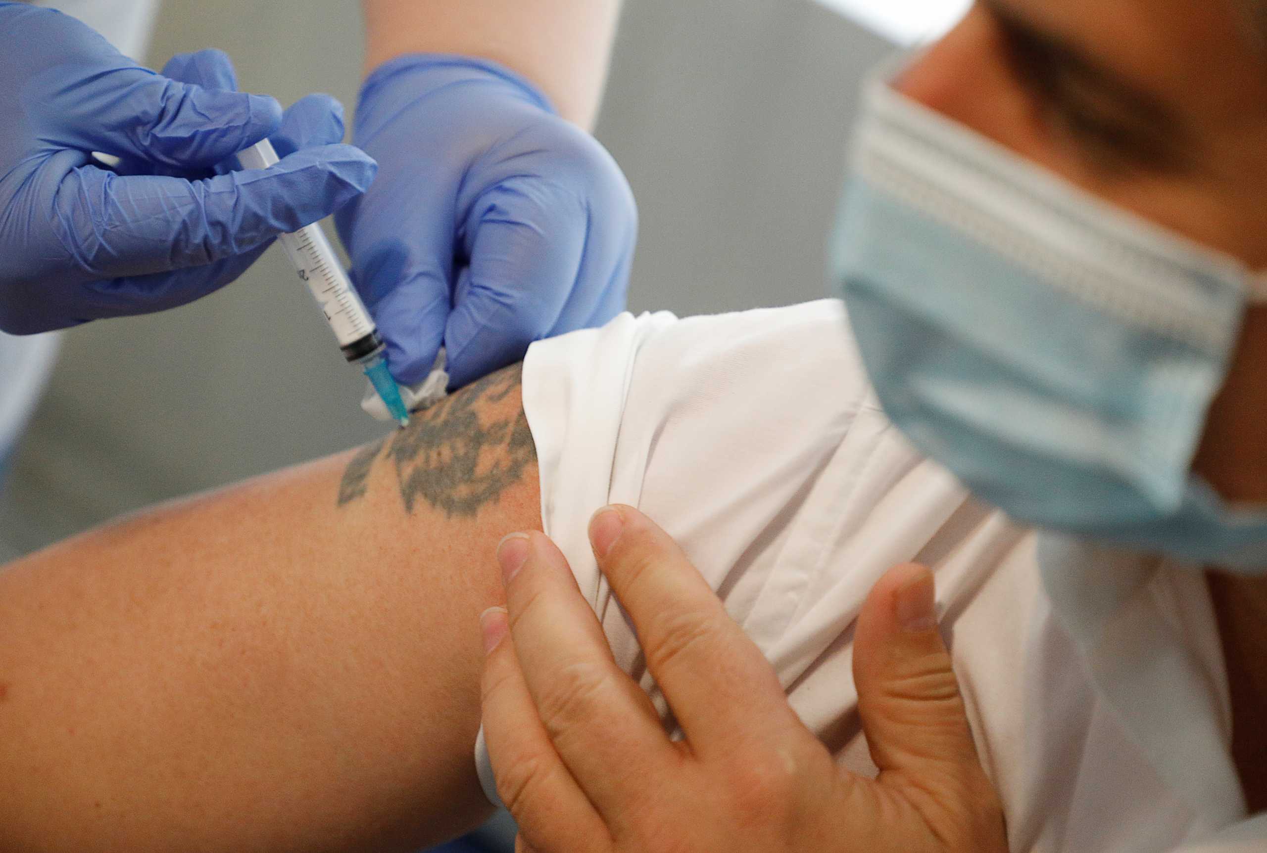 A man receives a dose of Sputnik V (Gam-COVID-Vac) vaccine against the coronavirus disease (COVID-19) administered by a healthcare worker from a mobile vaccination team in Stavropol, Russia June 23, 2021. REUTERS