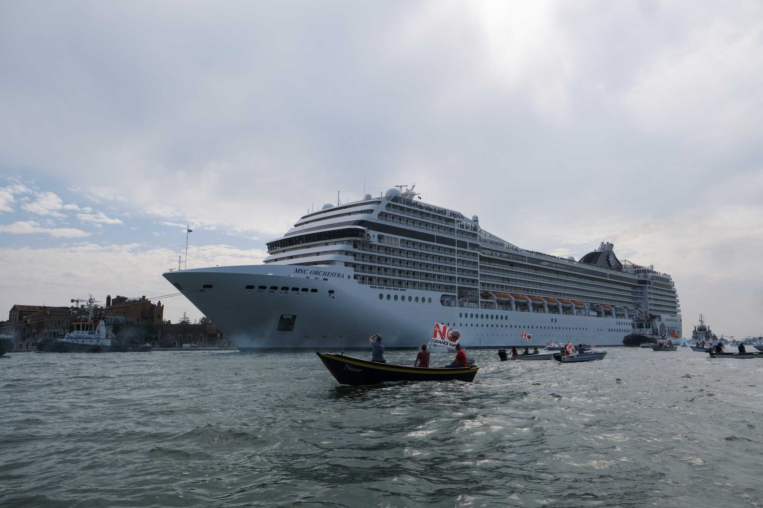 The first cruise ship of the summer season, the MSC Orchestra, departs from the Port of Venice, in the historic centre, en route to Bari, as people on boats hold a protest to demand an end to cruise ships passing through the lagoon city, in Venice, Italy, June 5, 2021. REUTERS