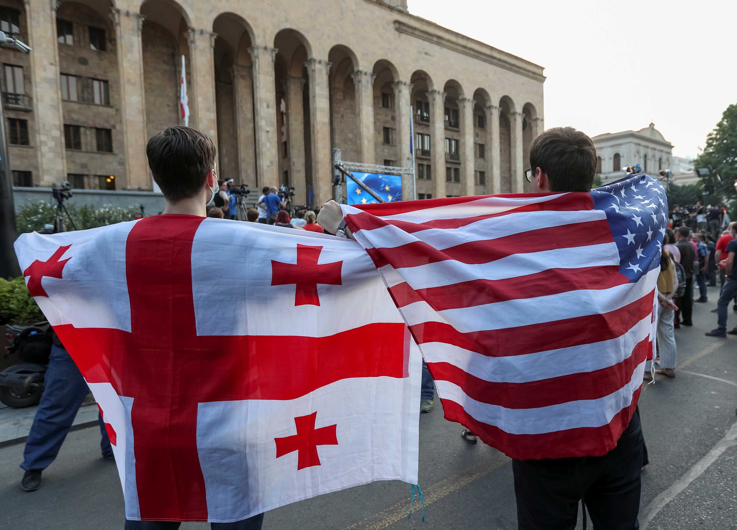 Opposition activists holding Georgian and U.S fags attend a rally, following the death of a cameraman who was beaten up during violence against LGBT activists last week, to demand the resignation of the prime minister and the government, in Tbilisi, Georgia July 12, 2021. REUTERS