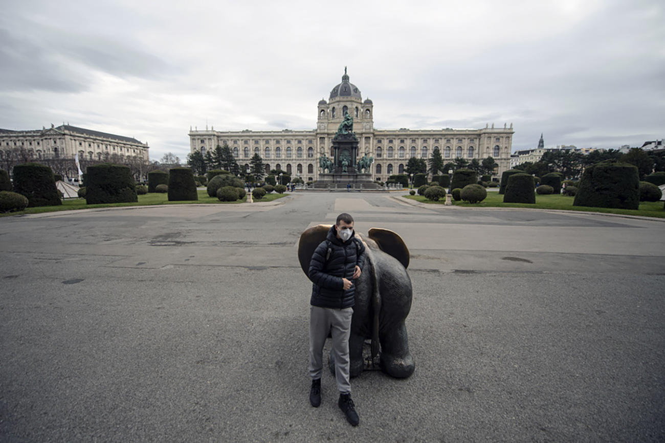 epa08285840 A man wearing a protective mask poses for photographs, with the closed Museum of Art History (KHM Kunsthistorisches Museum) in the background, in Vienna, Austria, 11 March 2020. In an attempt to stop the spreading of the novel coronavirus related Covid-19 disease, Austrian Chancellor announced on 10 March to close all state museums, the Vienna State Opera and other federal buildings. All public indoor gatherings with over 100 people and outdoor gatherings with 500 people have been banned and the population has been advised to reduce their social contacts.  EPA