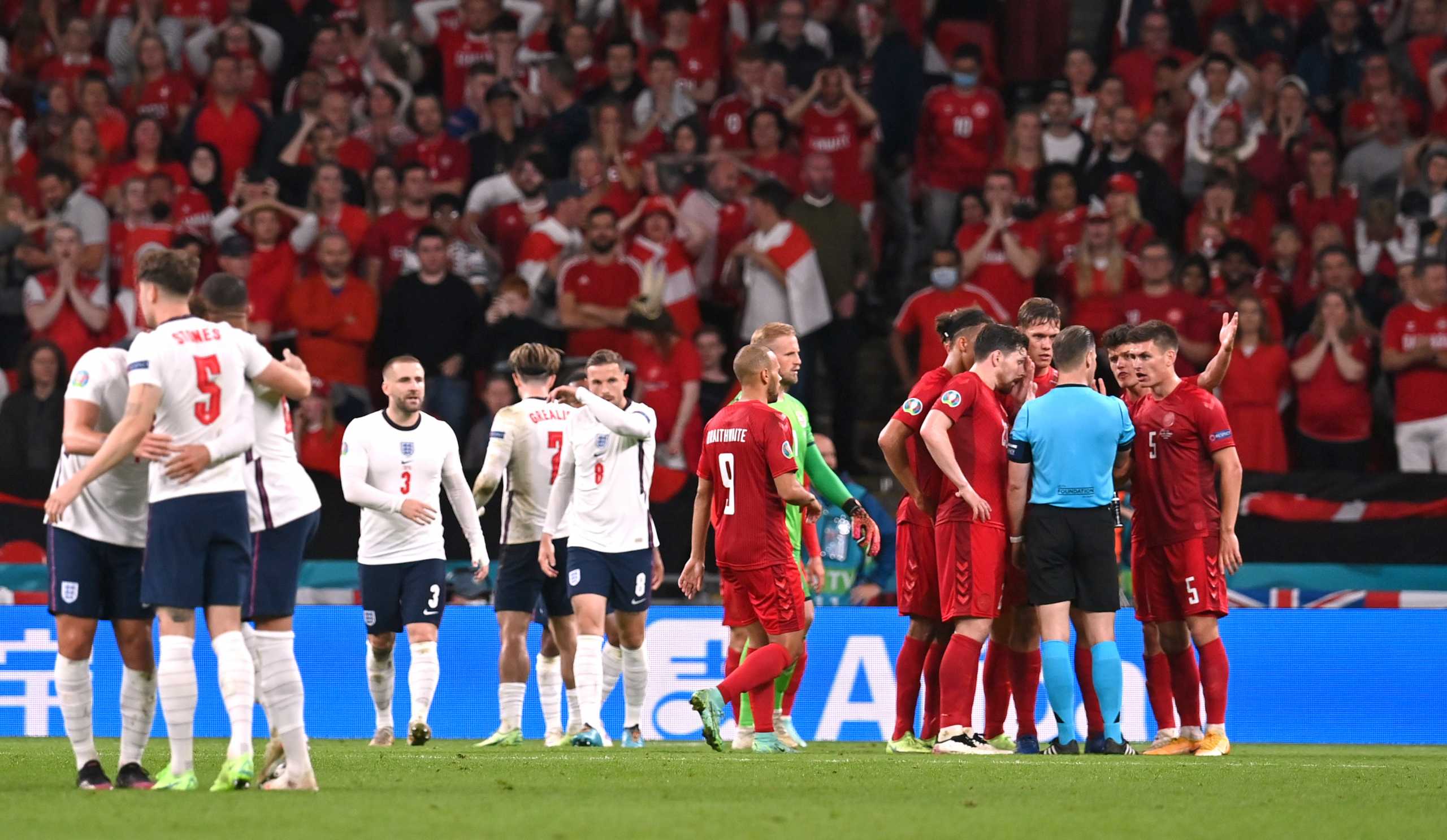 Soccer Football - Euro 2020 - Semi Final - England v Denmark - Wembley Stadium, London, Britain - July 7, 2021 Denmark players react after referee Danny Makkelie awards a penalty to England after a challenge on England's Raheem Sterling Pool via REUTERS