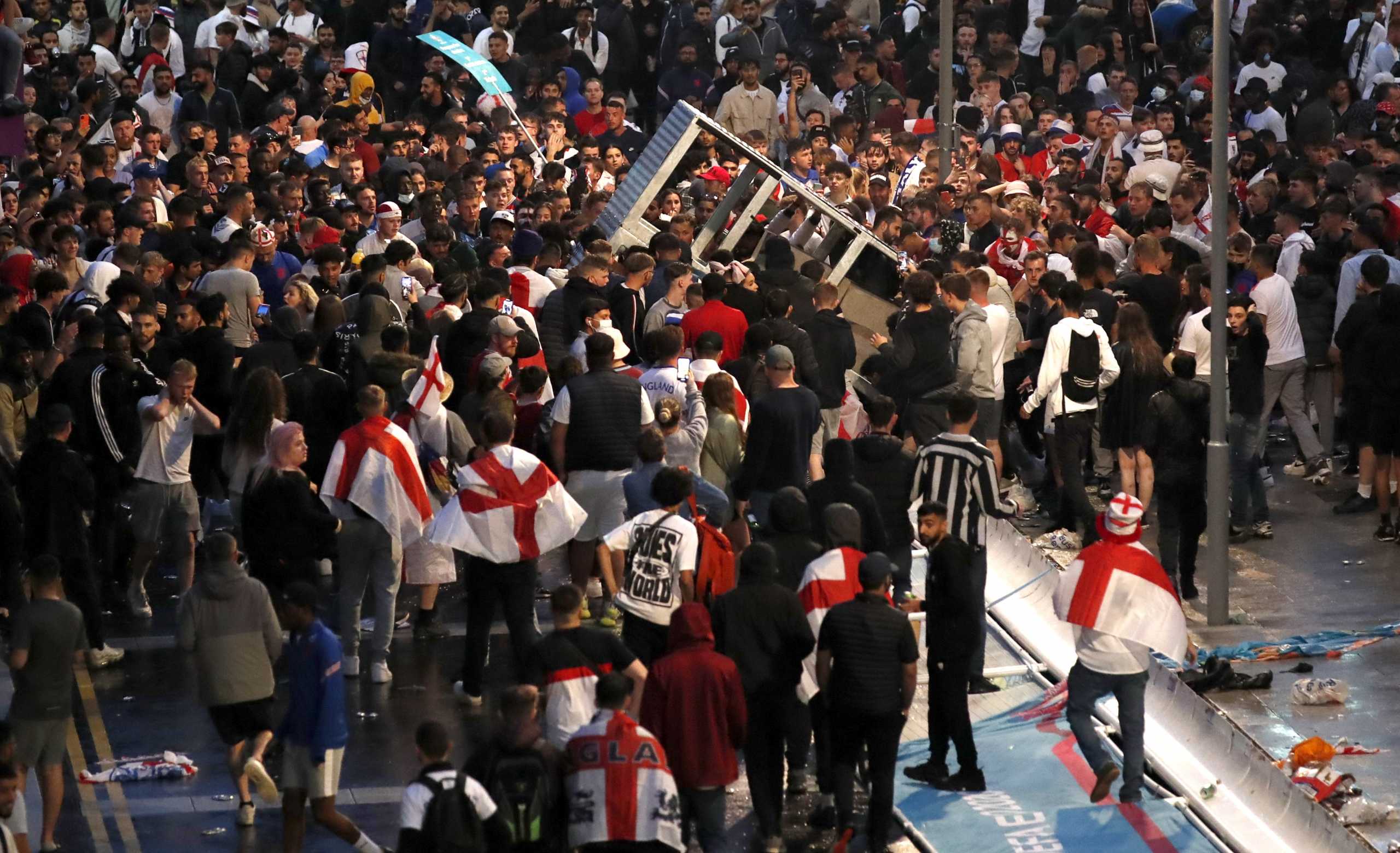 Soccer Football - Euro 2020 - Final - Fans gather for Italy v England - Wembley Stadium, London, Britain - July 11, 2021 England fans gather during the match outside Wembley Stadium Action Images via Reuters