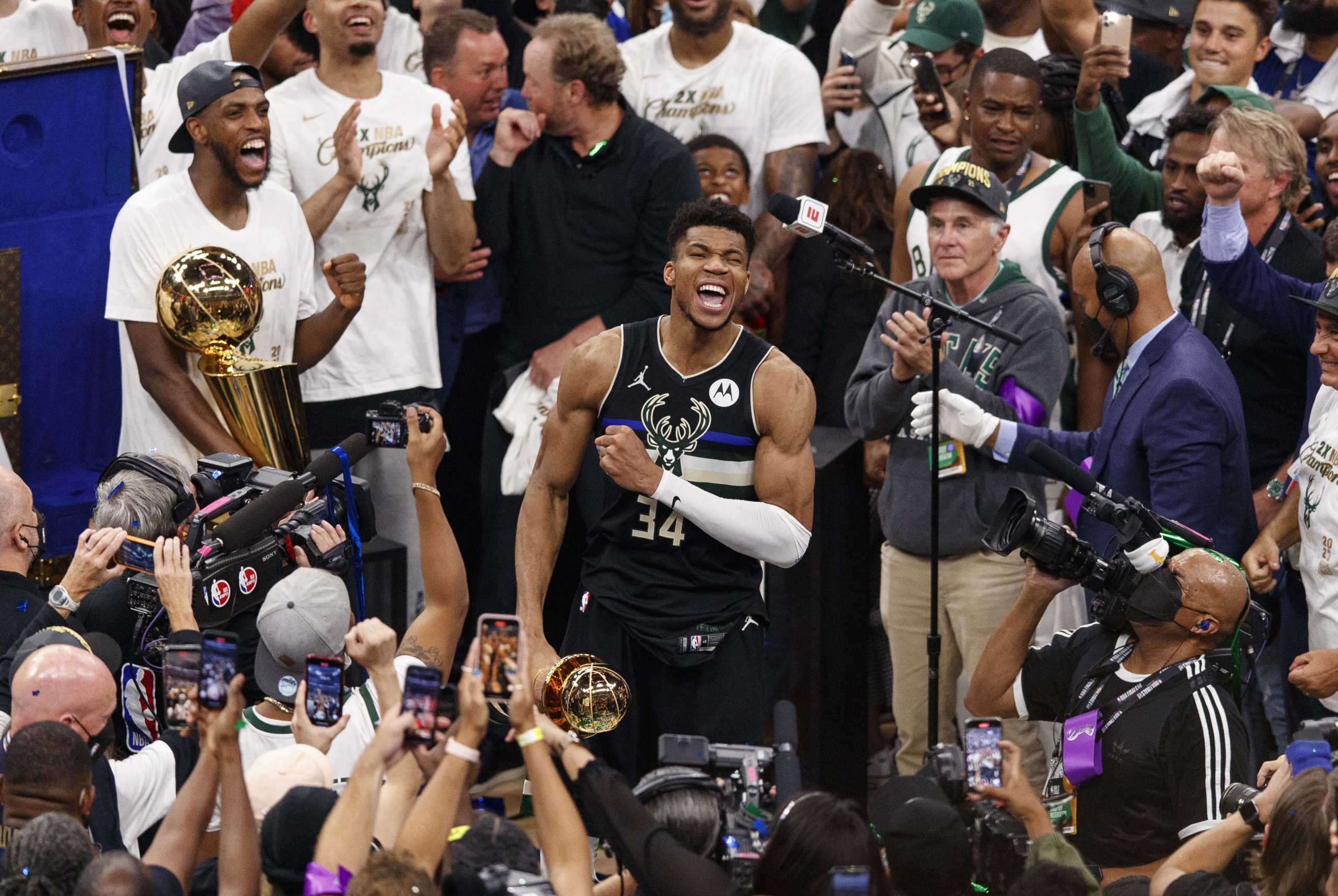 Jul 20, 2021; Milwaukee, Wisconsin, USA; Milwaukee Bucks forward Giannis Antetokounmpo (34) celebrates with the NBA Finals MVP Trophy following the game against the Phoenix Suns following game six of the 2021 NBA Finals at Fiserv Forum. Mandatory Credit: Jeff Hanisch-USA TODAY Sports