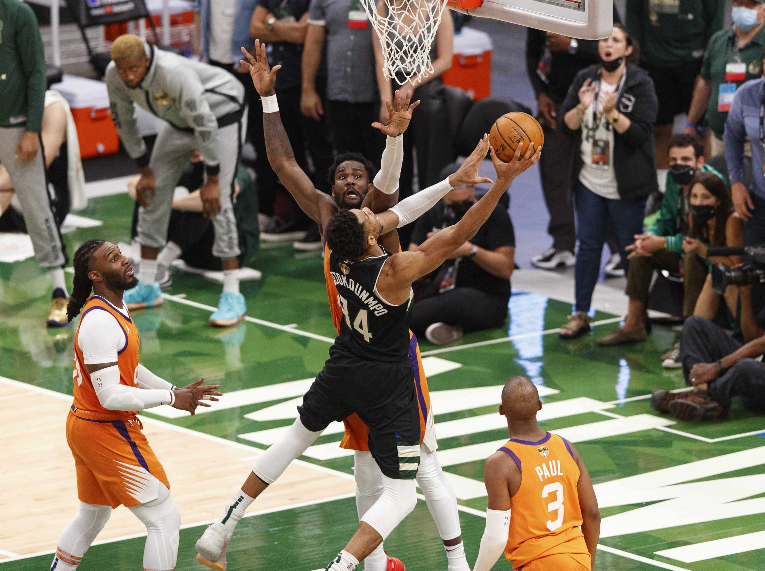 Jul 20, 2021; Milwaukee, Wisconsin, USA; Milwaukee Bucks forward Giannis Antetokounmpo (34) shoots against Phoenix Suns center Deandre Ayton (22) during the fourth quarter during game six of the 2021 NBA Finals at Fiserv Forum. Mandatory Credit: Jeff Hanisch-USA TODAY Sports