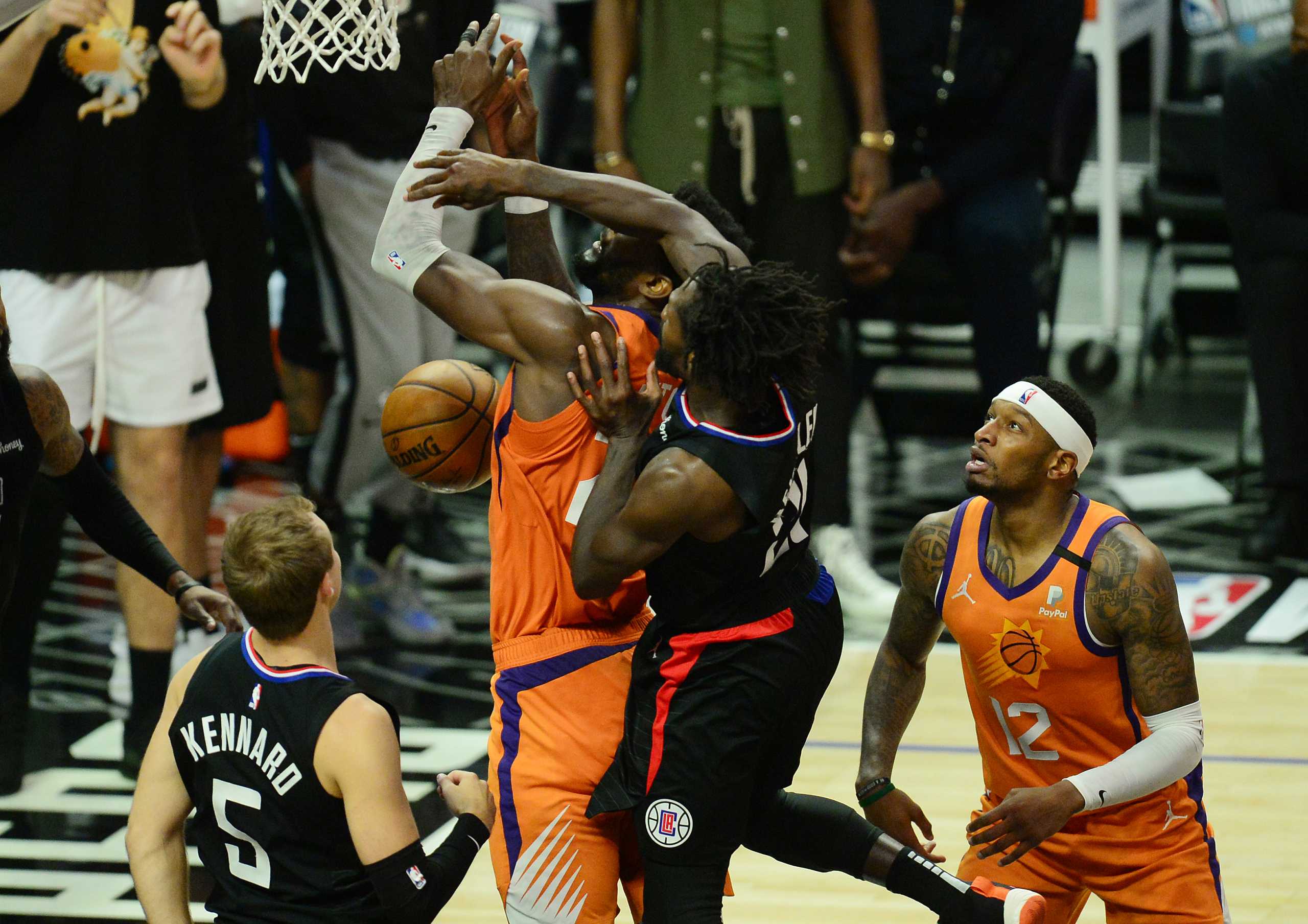 Jun 30, 2021; Los Angeles, California, USA; Los Angeles Clippers guard Patrick Beverley (21) stops a scoring attempt against Phoenix Suns center Deandre Ayton (22) during the first half in game six of the Western Conference Finals for the 2021 NBA Playoffs at Staples Center. Mandatory Credit: Gary A. Vasquez-USA TODAY Sports