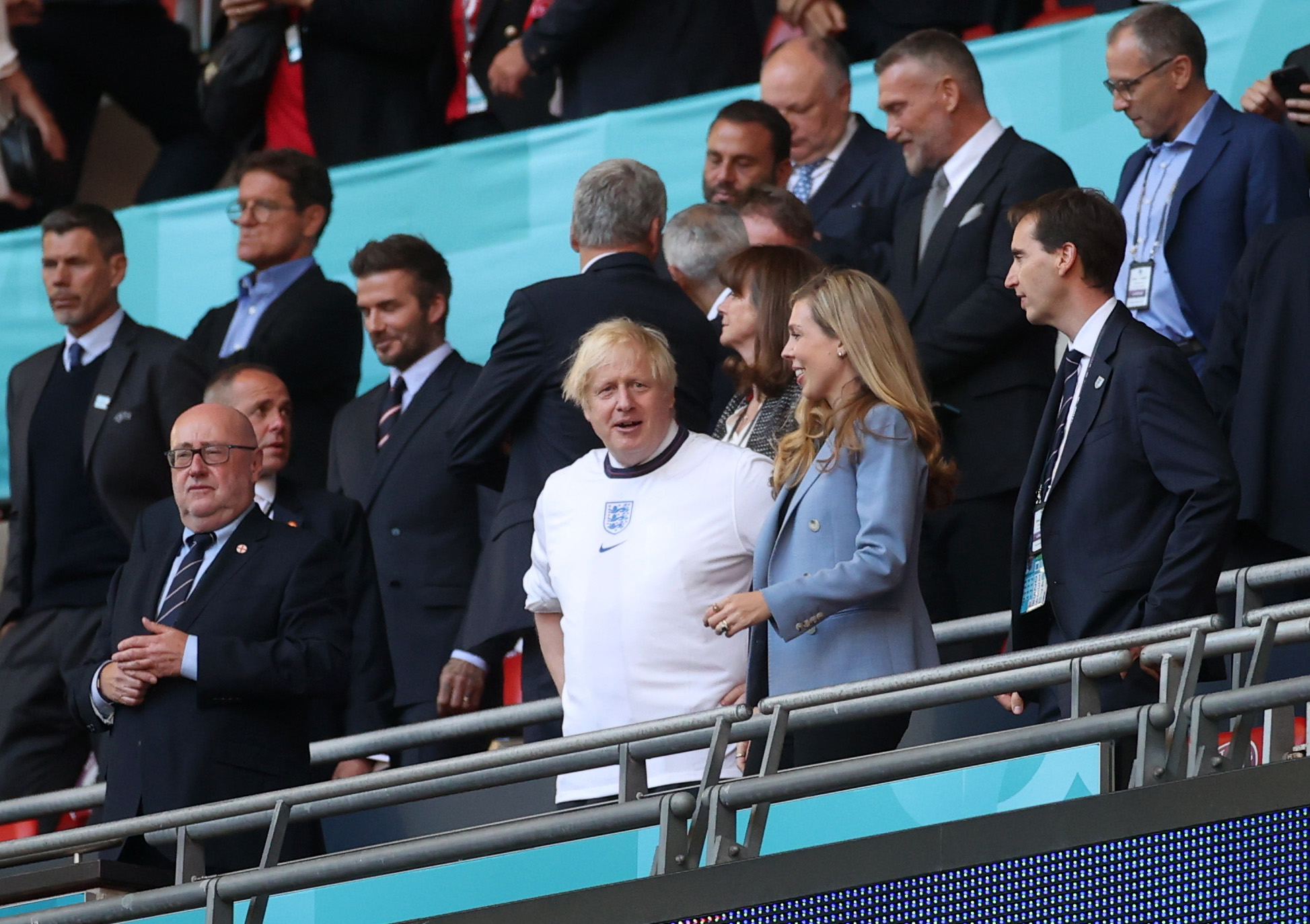 Soccer Football - Euro 2020 - Semi Final - England v Denmark - Wembley Stadium, London, Britain - July 7, 2021 Britain's Prime Minister Boris Johnson with his wife Carrie Johnson in the stands with former footballer David Beckham and former manager Fabio Capello before the match Pool via REUTERS