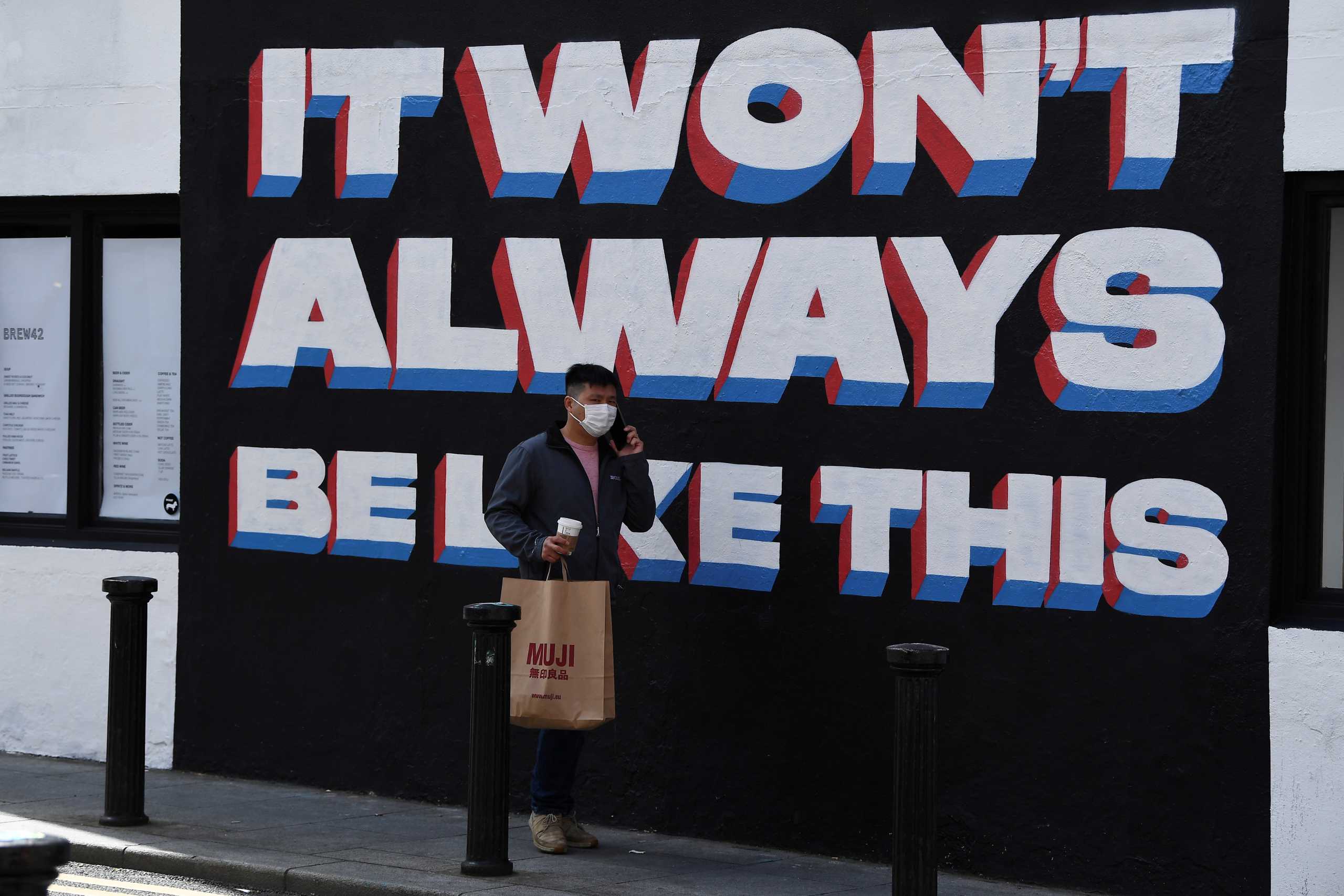 FILE PHOTO: A shopper carrying a bag walks on a street while retail reopens fully as coronavirus disease (COVID-19) restrictions continue to ease after an extensive lockdown period in Dublin, Ireland, May 17, 2021. REUTERS