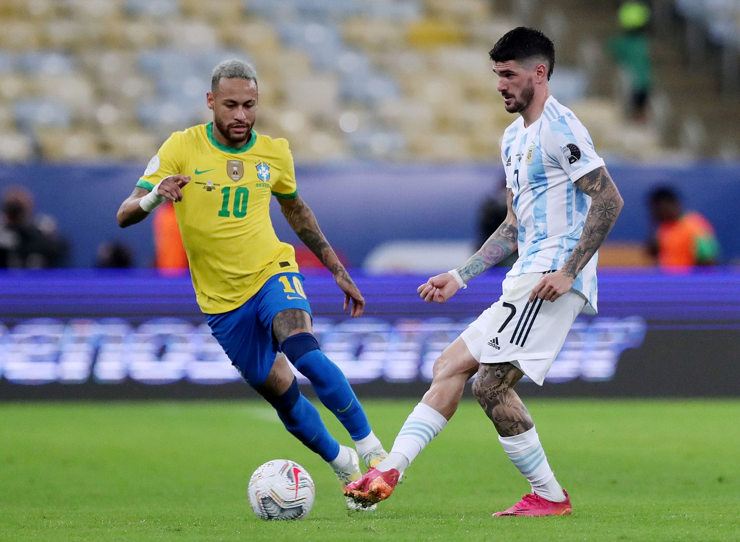 FILE PHOTO: Soccer Football - Copa America  2021 - Final - Brazil v Argentina - Estadio Maracana, Rio de Janeiro, Brazil - July 10, 2021 Argentina's Rodrigo De Paul  in action with Brazil's Neymar REUTERS