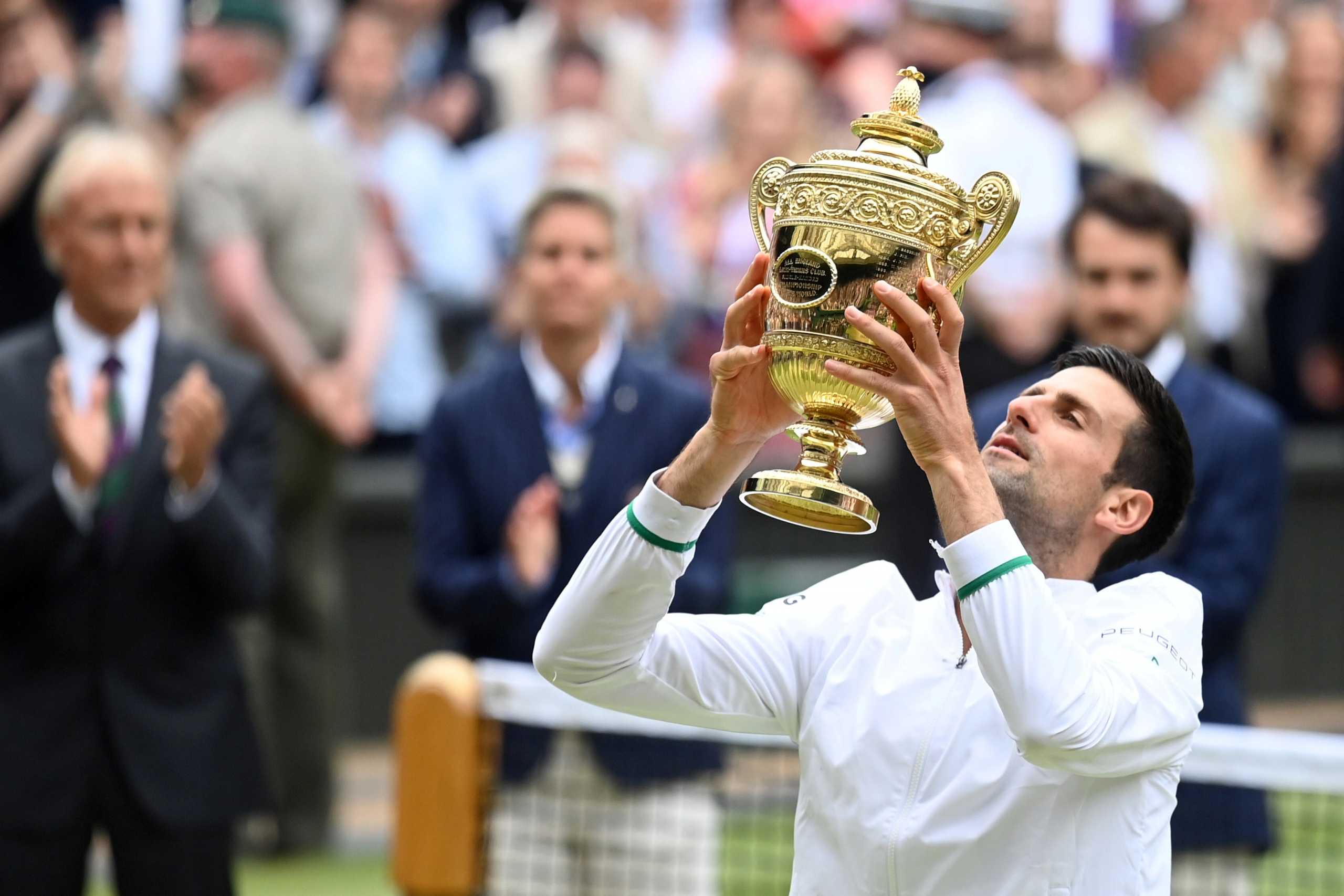 Tennis - Wimbledon - All England Lawn Tennis and Croquet Club, London, Britain - July 11, 2021 Serbia's Novak Djokovic celebrates with the trophy after winning his final match against Italy's Matteo Berrettini REUTERS