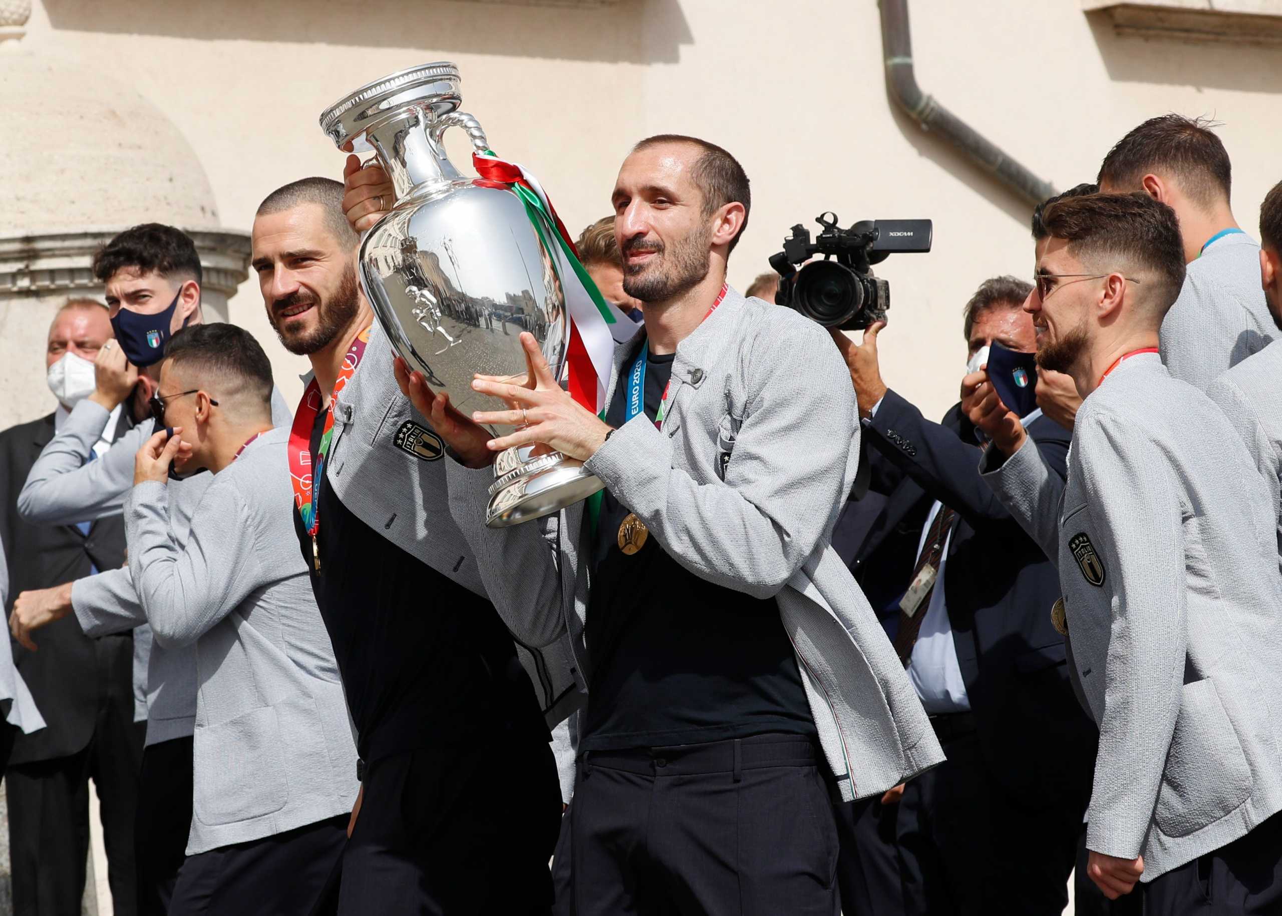 Soccer Football - Euro 2020 - Italy's President Sergio Mattarella meets with the Italy team after they won Euro 2020 - Quirinale Palace, Rome, Italy - July 12, 2021 Italy's Giorgio Chiellini with Leonardo Bonucci and teammates as he holds the European Championship trophy before meeting Italy's President Sergio Mattarella REUTERS