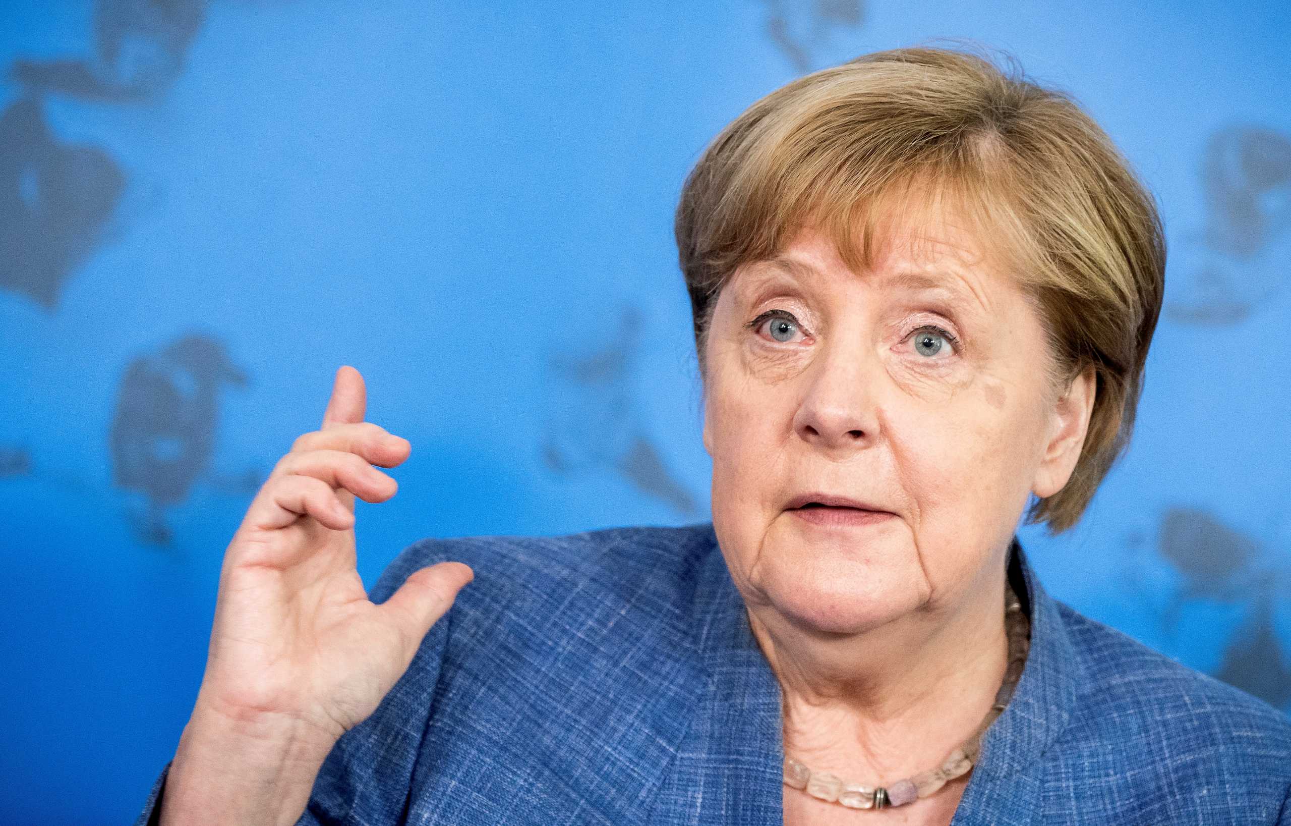 FILE PHOTO: German Chancellor Angela Merkel speaks during a news conference on coronavirus disease (COVID-19) situation, in Berlin, Germany, July 13, 2021. Michael Kappeler