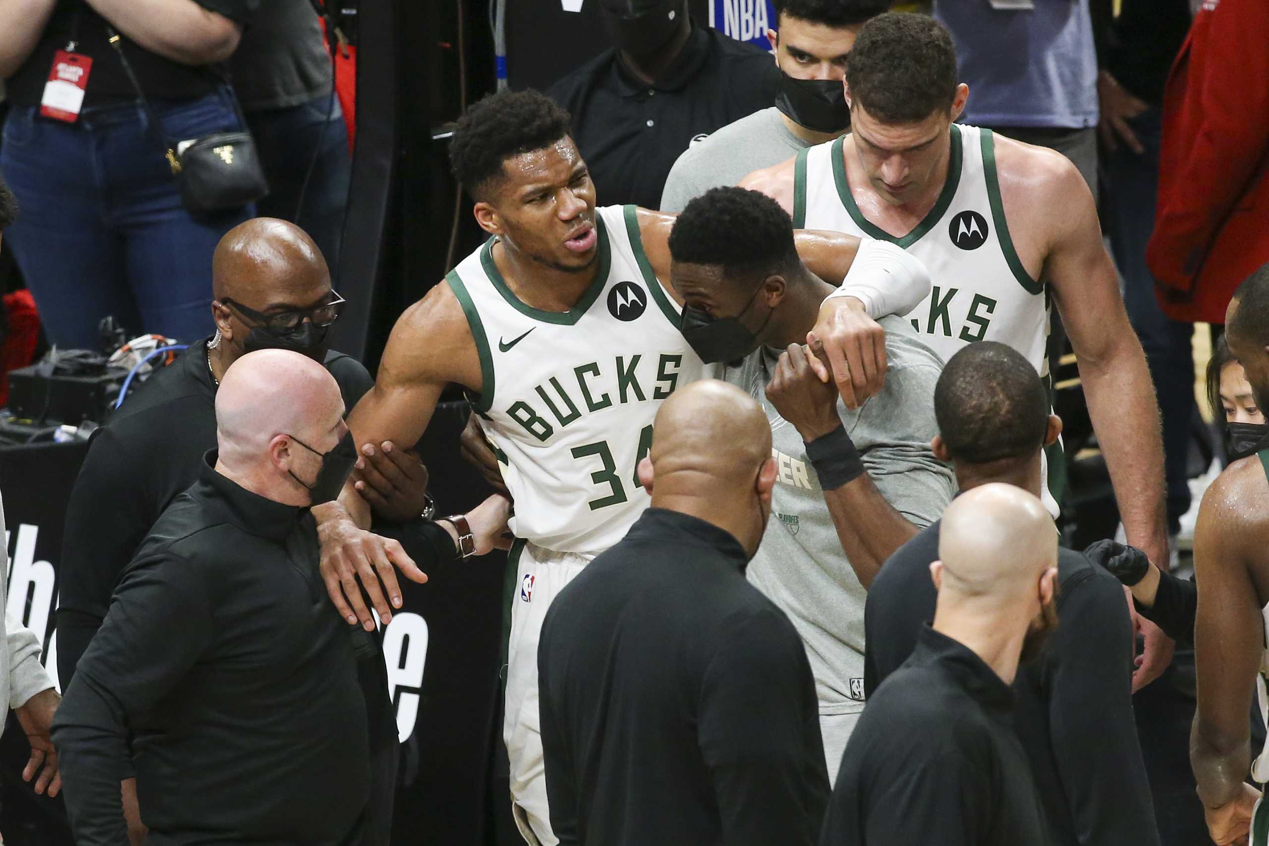 Jun 29, 2021; Atlanta, Georgia, USA; Milwaukee Bucks forward Giannis Antetokounmpo (34) is helped off the court with an injury against the Atlanta Hawks in the third quarter during game four of the Eastern Conference Finals for the 2021 NBA Playoffs at State Farm Arena. Mandatory Credit: Brett Davis-USA TODAY Sports