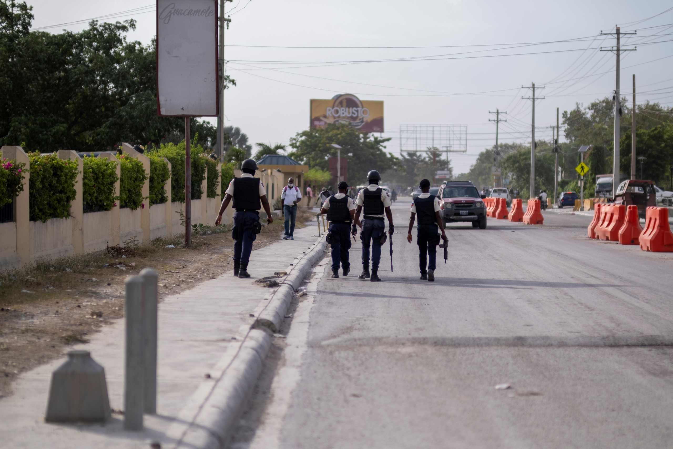 Haitian National Policemen patrol the the street in front of the U.S. Embassy as people gather to ask for asylum following the assassination of President Jovenel Moise, in Port-au-Prince, Haiti July 9, 2021.  REUTERS