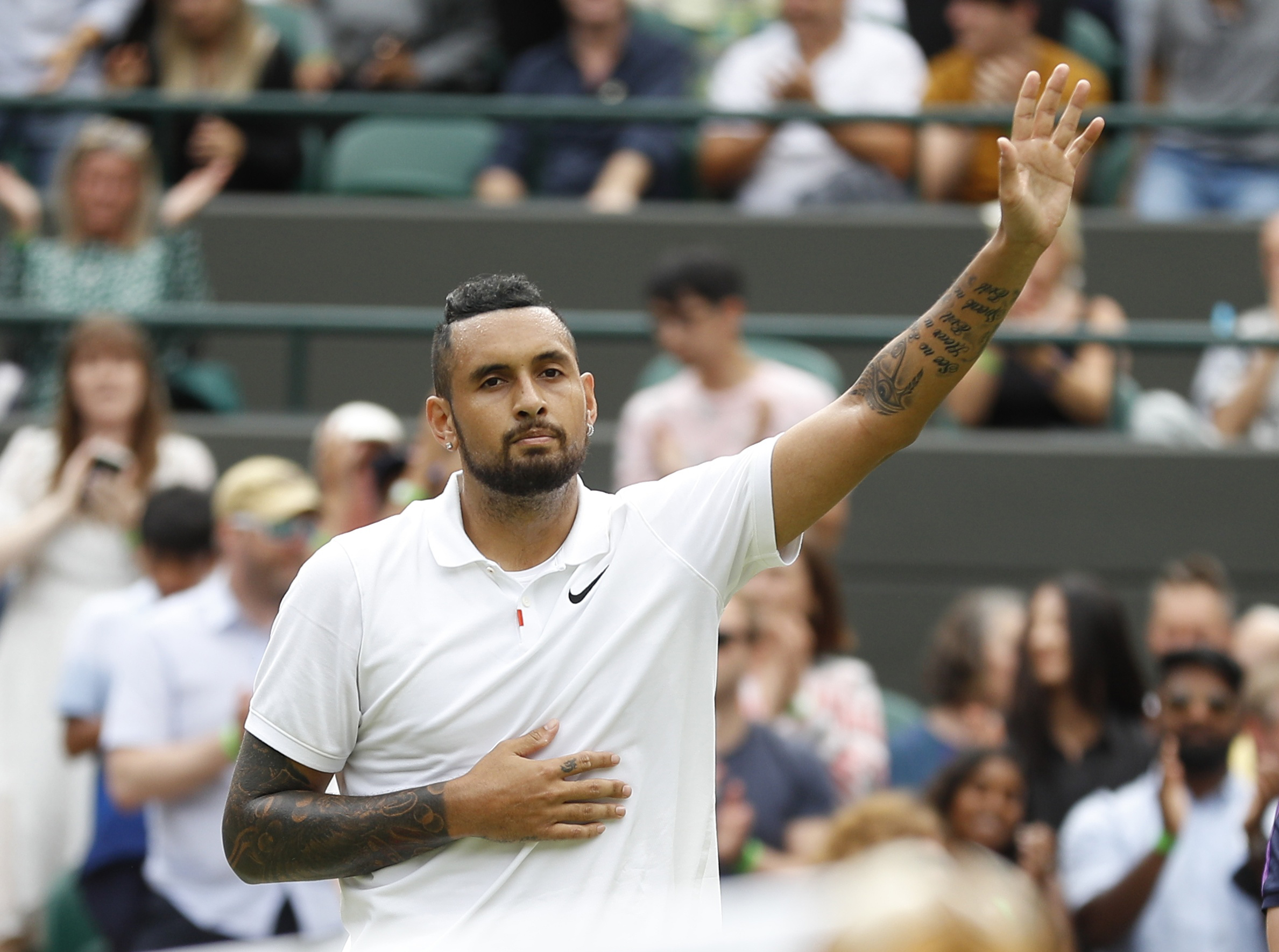 Tennis - Wimbledon - All England Lawn Tennis and Croquet Club, London, Britain - July 3, 2021  Australia's Nick Kyrgios waves to the spectators after losing his match by a walkover as he sustained an injury REUTERS