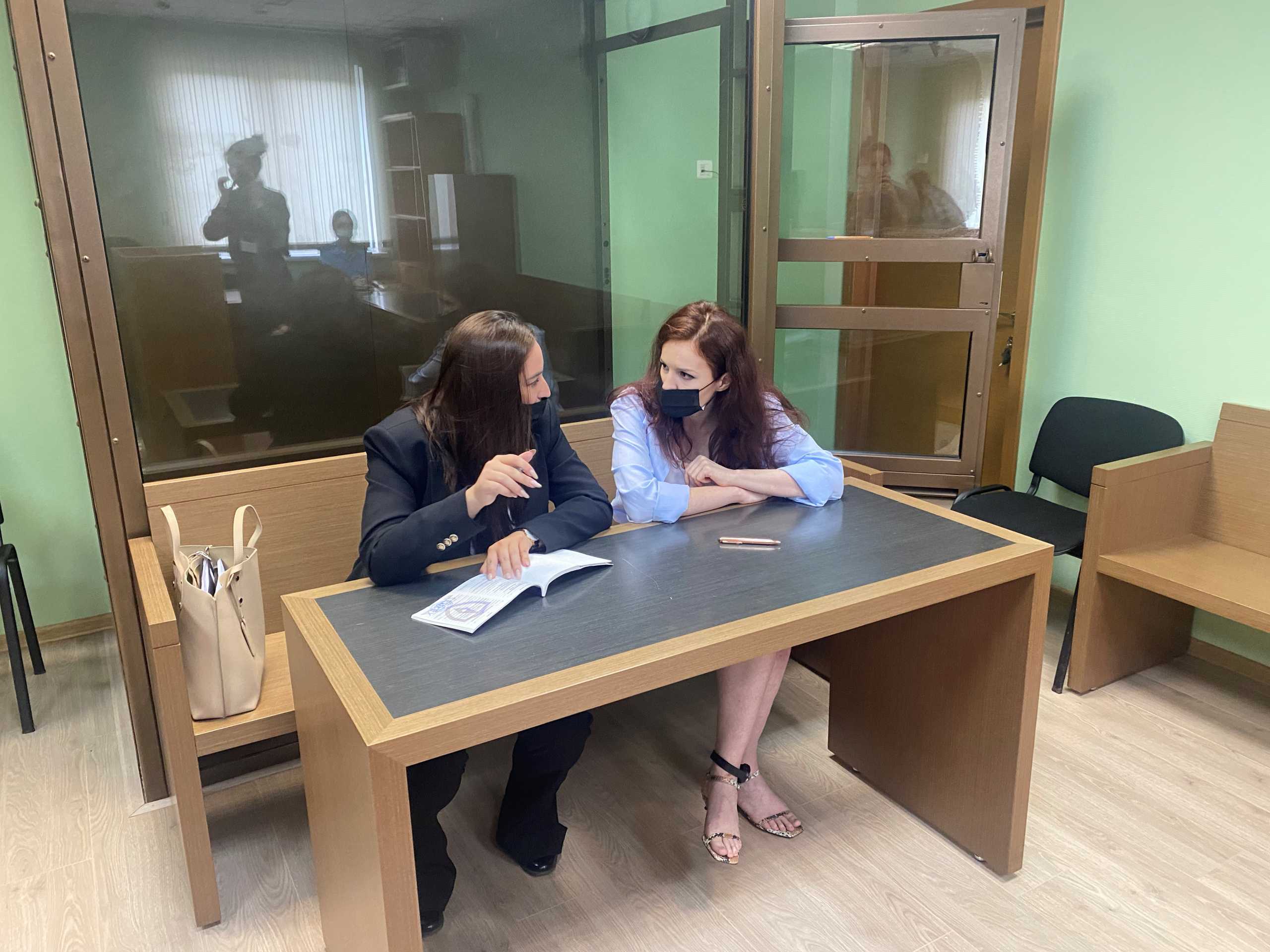Kira Yarmysh (R), spokesperson for jailed Kremlin critic Alexei Navalny, attends a court hearing in Moscow, Russia July 21, 2021. Yarmysh has been under house arrest since February for allegedly breaching COVID-19 safety regulations at an unauthorised protest in support of Navalny. Press Service of Preobrazhensky District Court of Moscow