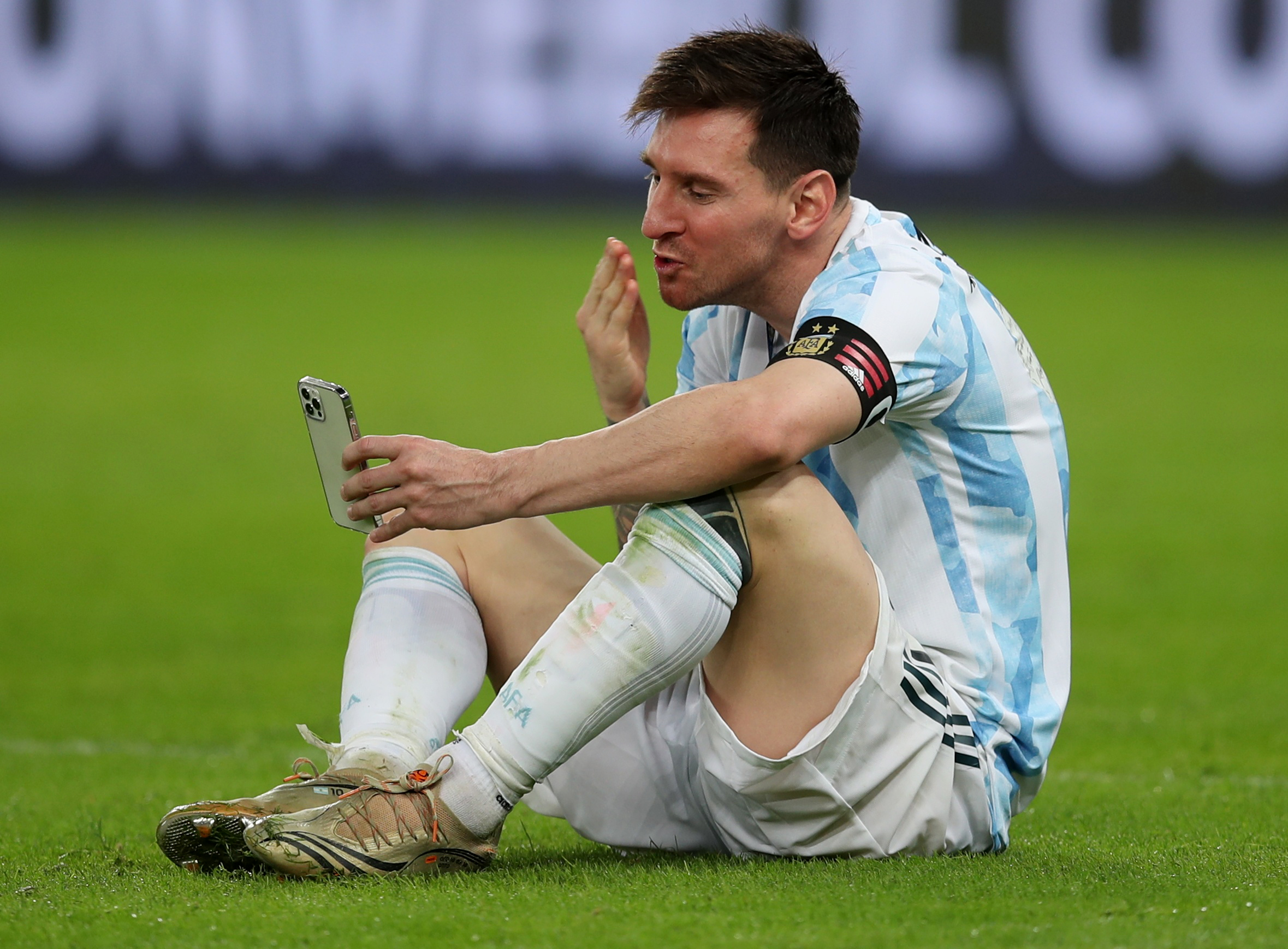 Soccer Football - Copa America  2021 - Final - Brazil v Argentina - Estadio Maracana, Rio de Janeiro, Brazil - July 10, 2021 Argentina's Lionel Messi in a video-call at the pitch after winning the Copa America REUTERS