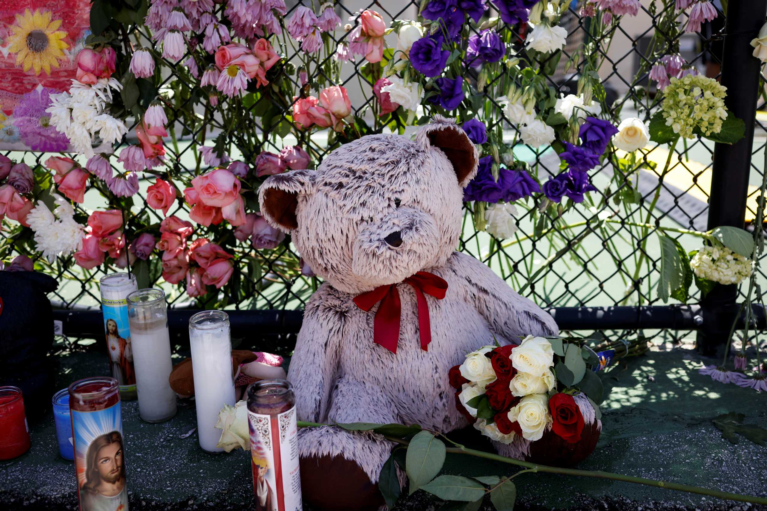 Toys and flowers hang on a fence at the memorial for victims of a partially collapsed residential building as the emergency crews continue the search and rescue operations for survivors, in Surfside, near Miami Beach, Florida, U.S. July 2, 2021. REUTERS