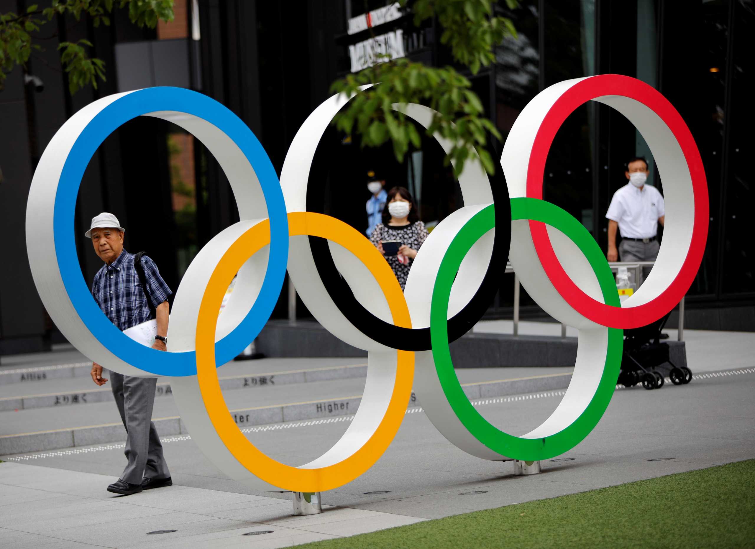 Kohei Jinno, 87, who was forced to leave his house two times ahead of the 1964 and 2020 Olympics Games to make way for construction of the main stadium, walks next to the Olympic Rings monument outside the Japan Olympic Museum near the National Stadium, the main stadium for the 2020 Tokyo Olympic Games that have been postponed to 2021 due to the coronavirus disease (COVID-19) pandemic, in Tokyo, Japan June 24, 2021. Picture taken June 24, 2021.    REUTERS