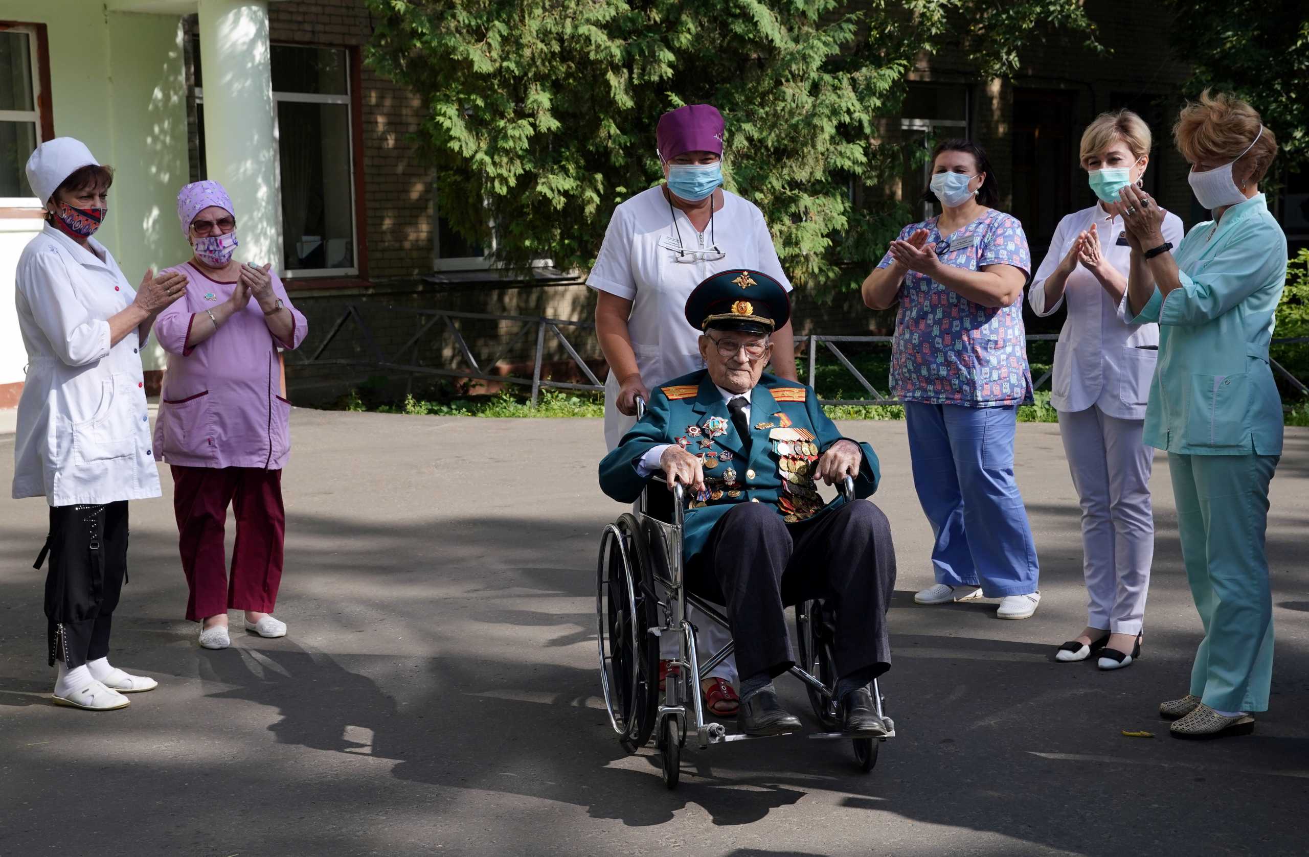 World War Two veteran Nikolay Bagayev, 102, leaves a hospital after being treated for the coronavirus disease (COVID-19) and discharged, in Korolyov, Moscow region, Russia July 22, 2021. Picture taken July 22, 2021. REUTERS