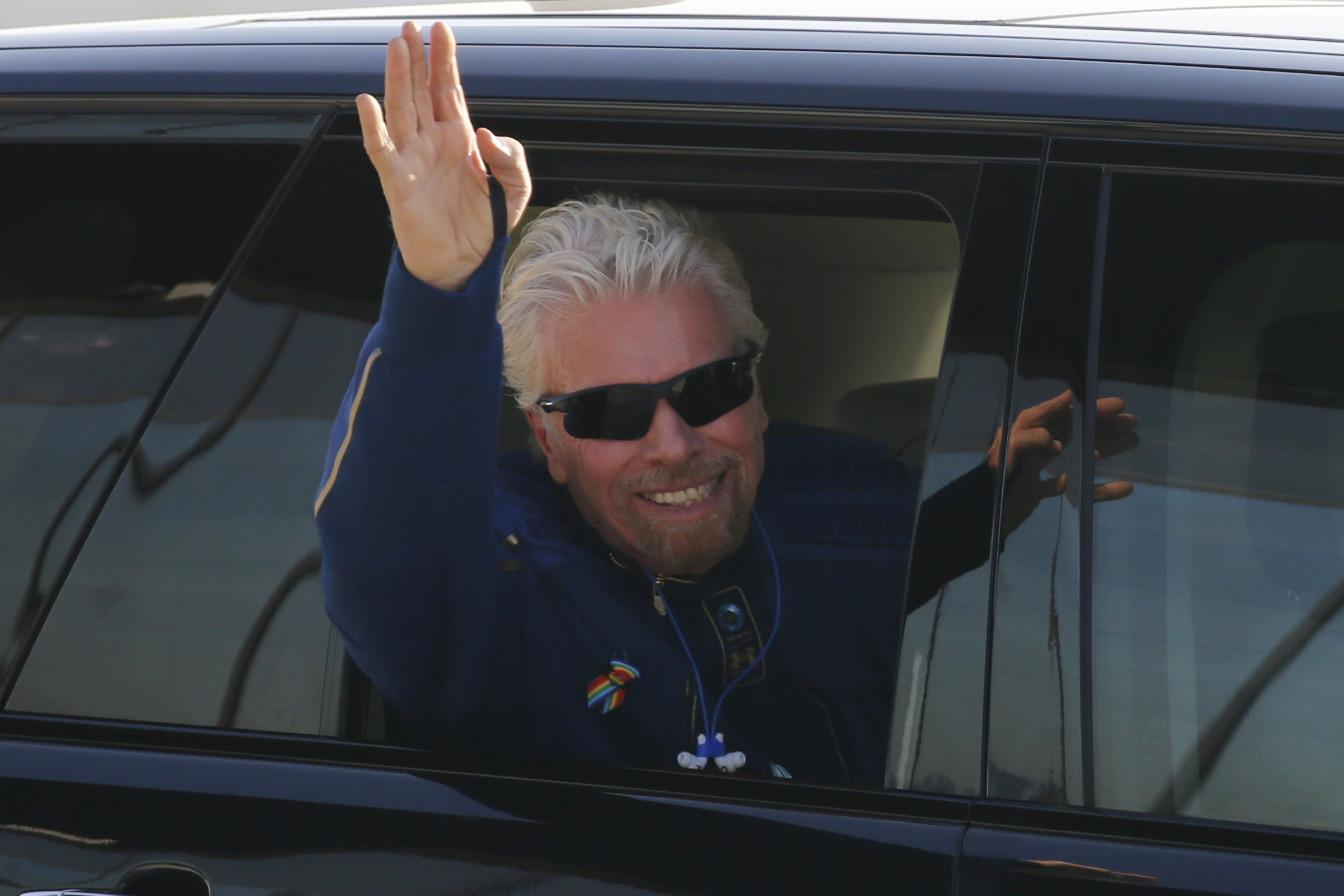 Billionaire entrepreneur Richard Branson departs with his crew prior to boarding, for travel to the edge of space in Virgin Galactic's passenger rocket plane VSS Unity, near Truth or Consequences, New Mexico, U.S., July 11, 2021. REUTERS