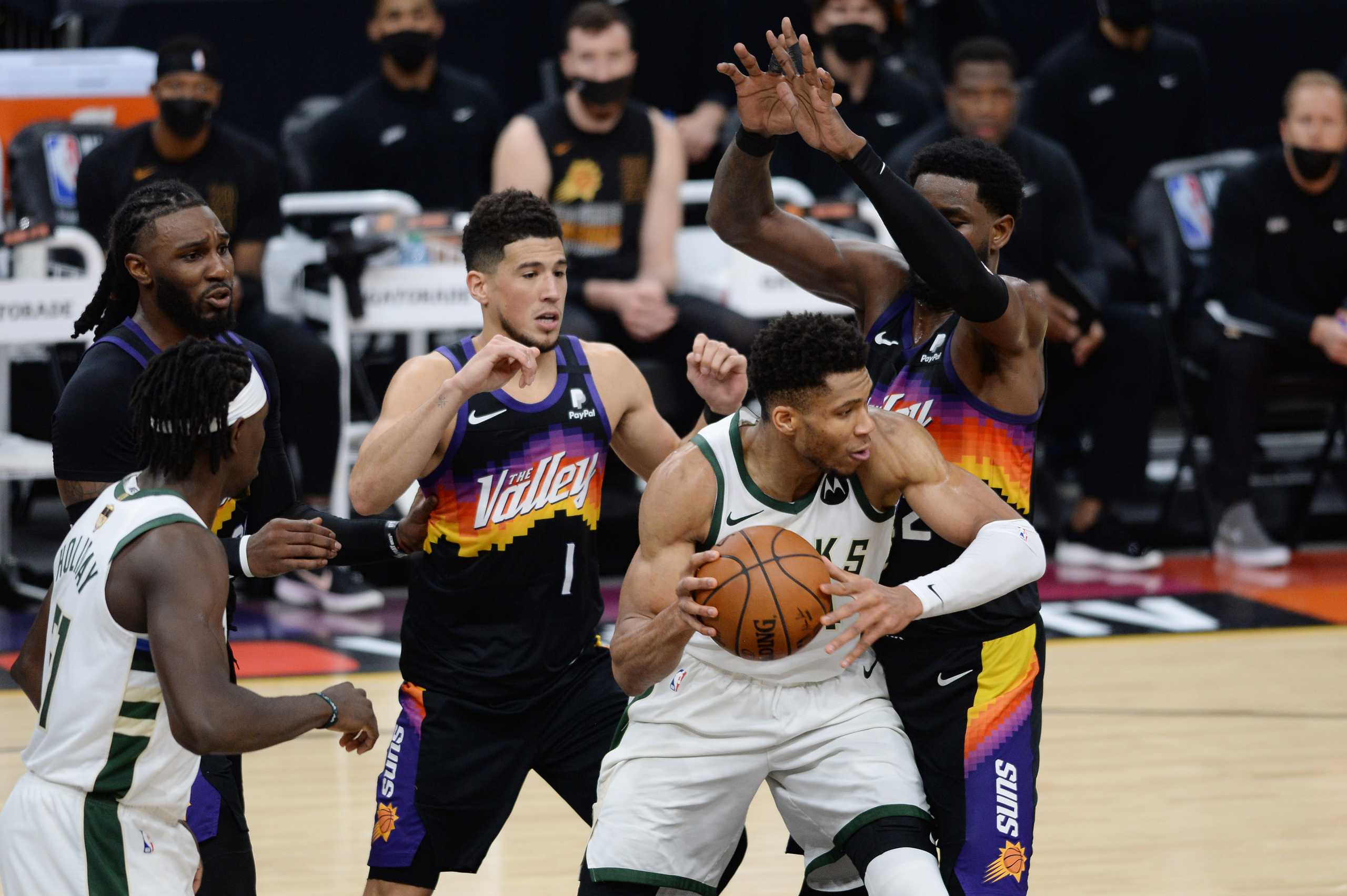 Jul 17, 2021; Phoenix, Arizona, USA; Milwaukee Bucks forward Giannis Antetokounmpo (34) attempts to control the ball as Phoenix Suns center Deandre Ayton (22) defends in the first half during game five of the 2021 NBA Finals at Phoenix Suns Arena. Mandatory Credit: Joe Camporeale-USA TODAY Sports
