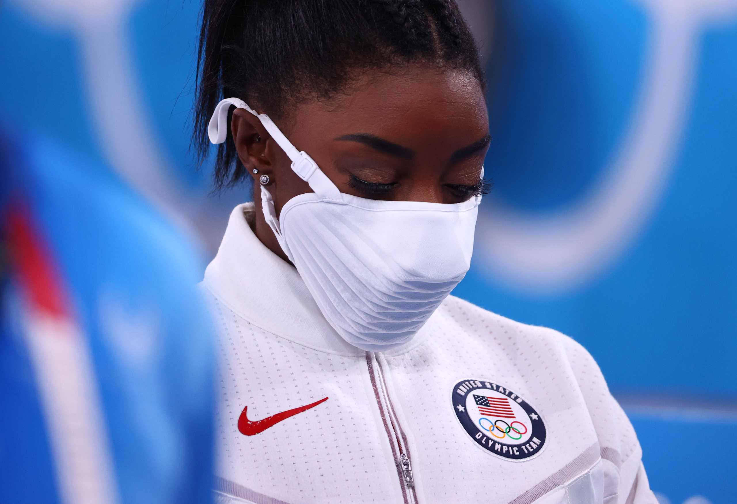 Tokyo 2020 Olympics - Gymnastics - Artistic - Women's Team - Final - Ariake Gymnastics Centre, Tokyo, Japan - July 27, 2021.  Simone Biles of the United States wearing a protective face mask looks down. REUTERS