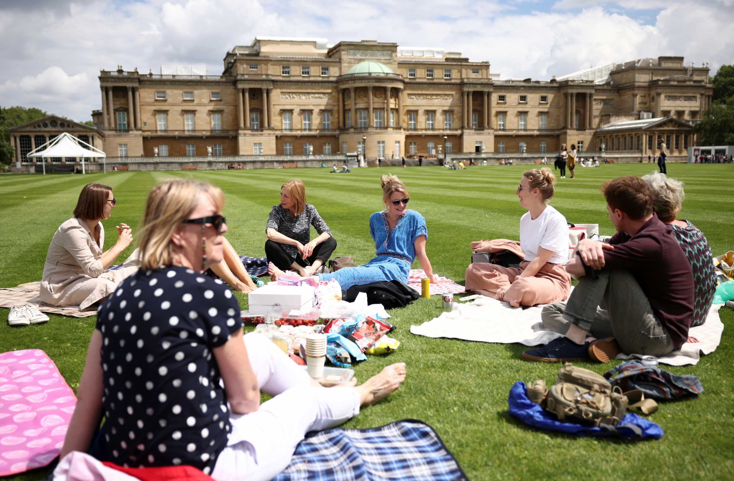 A group has a picnic in the The Garden of Buckingham Palace, during a preview day before it opens to the public, in London, Britain, July 8, 2021. REUTERS