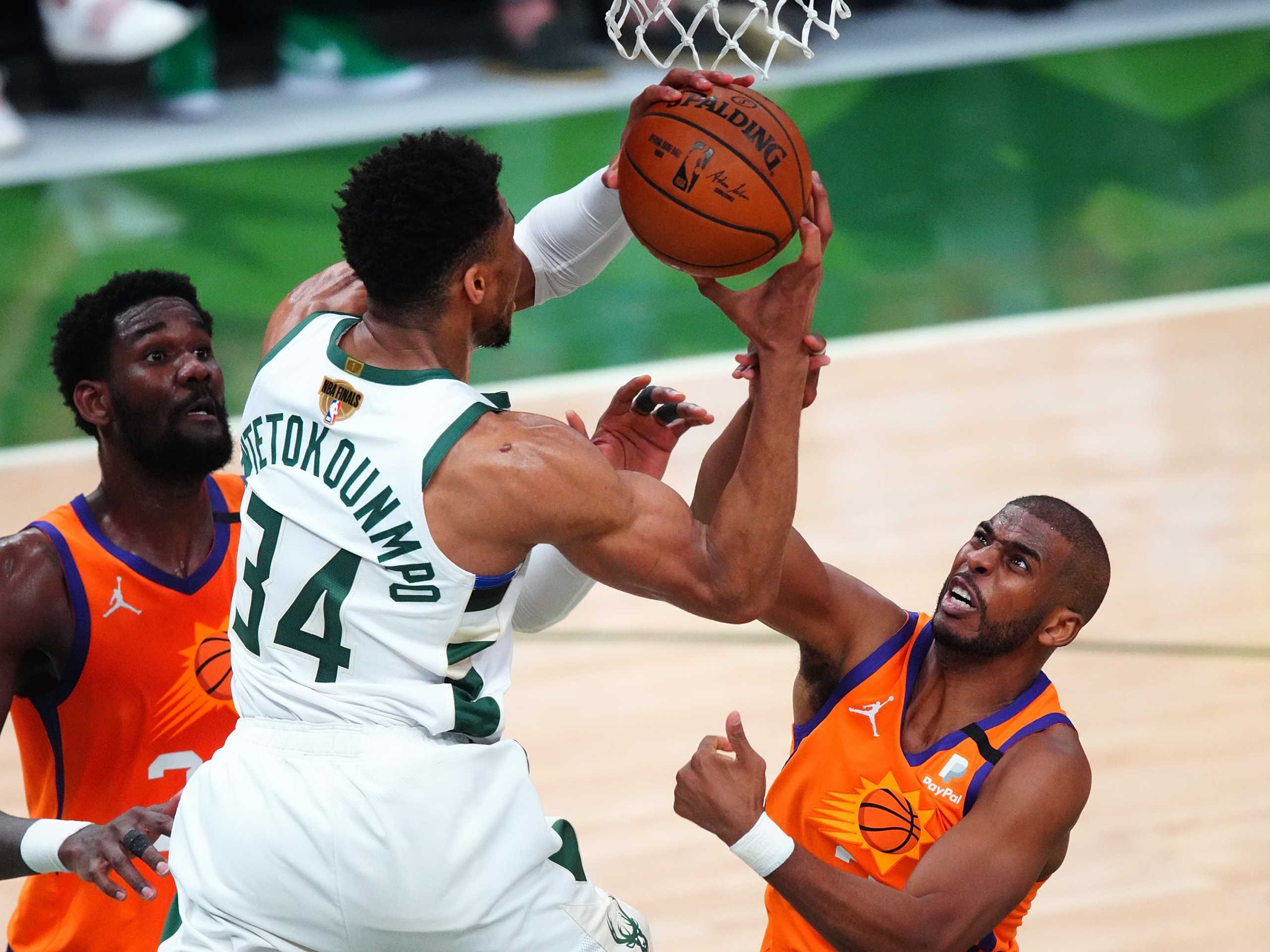 Jul 14, 2021; Milwaukee, Wisconsin, USA; Phoenix Suns guard Chris Paul (3) fouls Milwaukee Bucks forward Giannis Antetokounmpo (34) during the third quarter in game four of the 2021 NBA Finals at Fiserv Forum. Mandatory Credit: Mark J. Rebilas-USA TODAY Sports