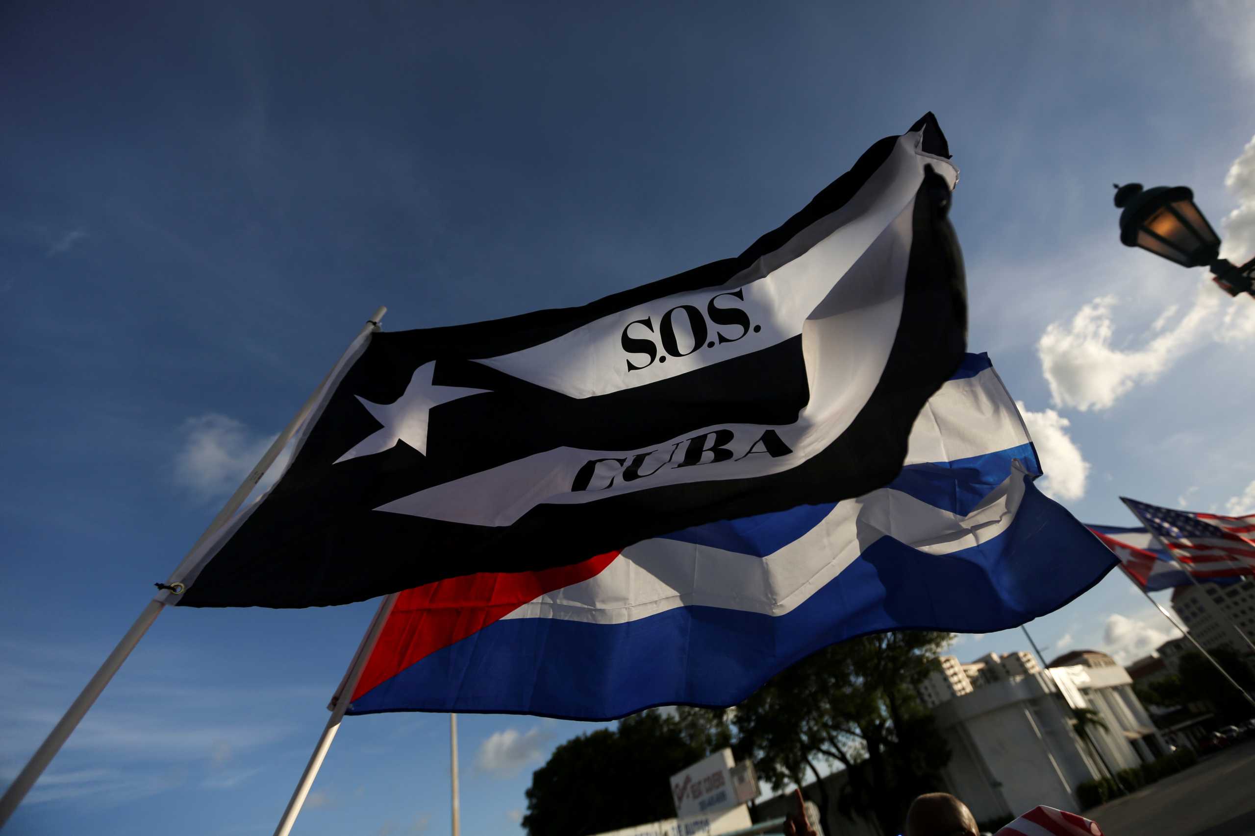 FILE PHOTO: Emigres wave flags outside Versailles restaurant, in reaction to reports of protests in Cuba against its deteriorating economy, in Miami, Florida, U.S. July 18, 2021. REUTERS