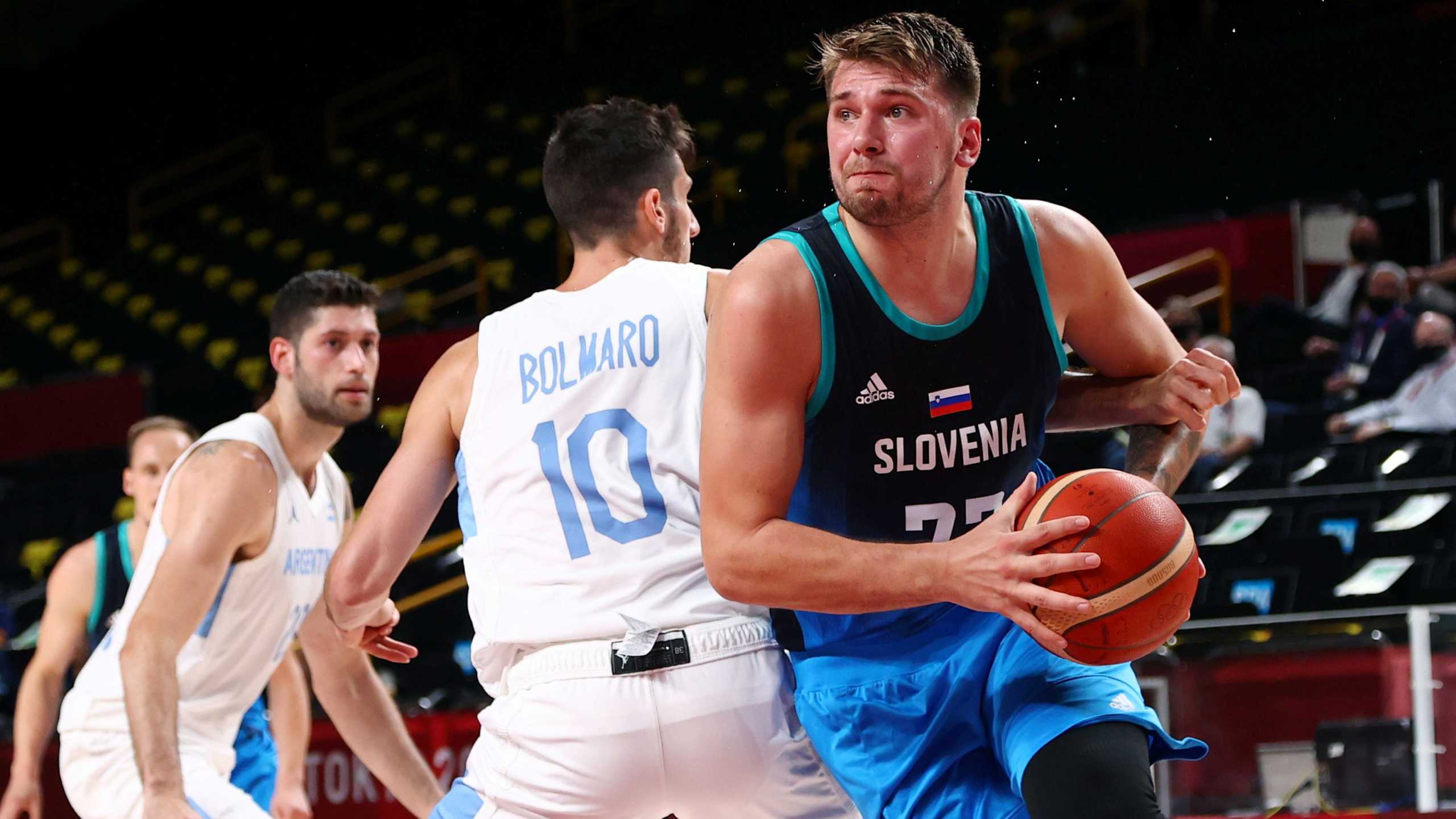 Tokyo 2020 Olympics - Basketball - Men - Group C - Argentina v Slovenia - Saitama Super Arena, Saitama, Japan - July 26, 2021. Luka Doncic of Slovenia in action with Leandro Nicolas Bolmaro of Argentina REUTERS