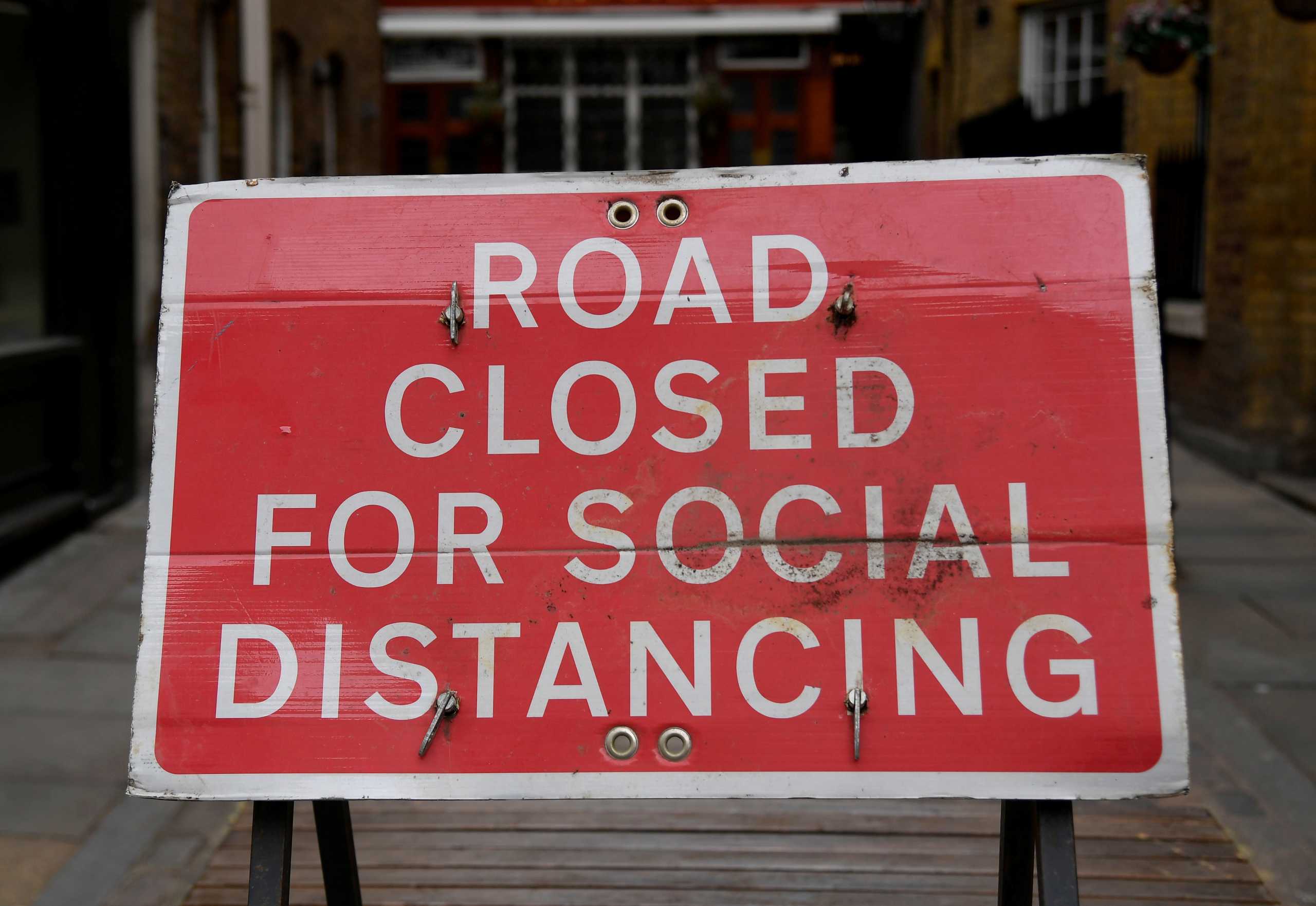 FILE PHOTO: A sign is seen on a road in Covent Garden ahead of a further easing of lockdown restrictions for England on April 12, amid the spread of the coronavirus disease (COVID-19) pandemic, in London, Britain, April 6, 2021. REUTERS