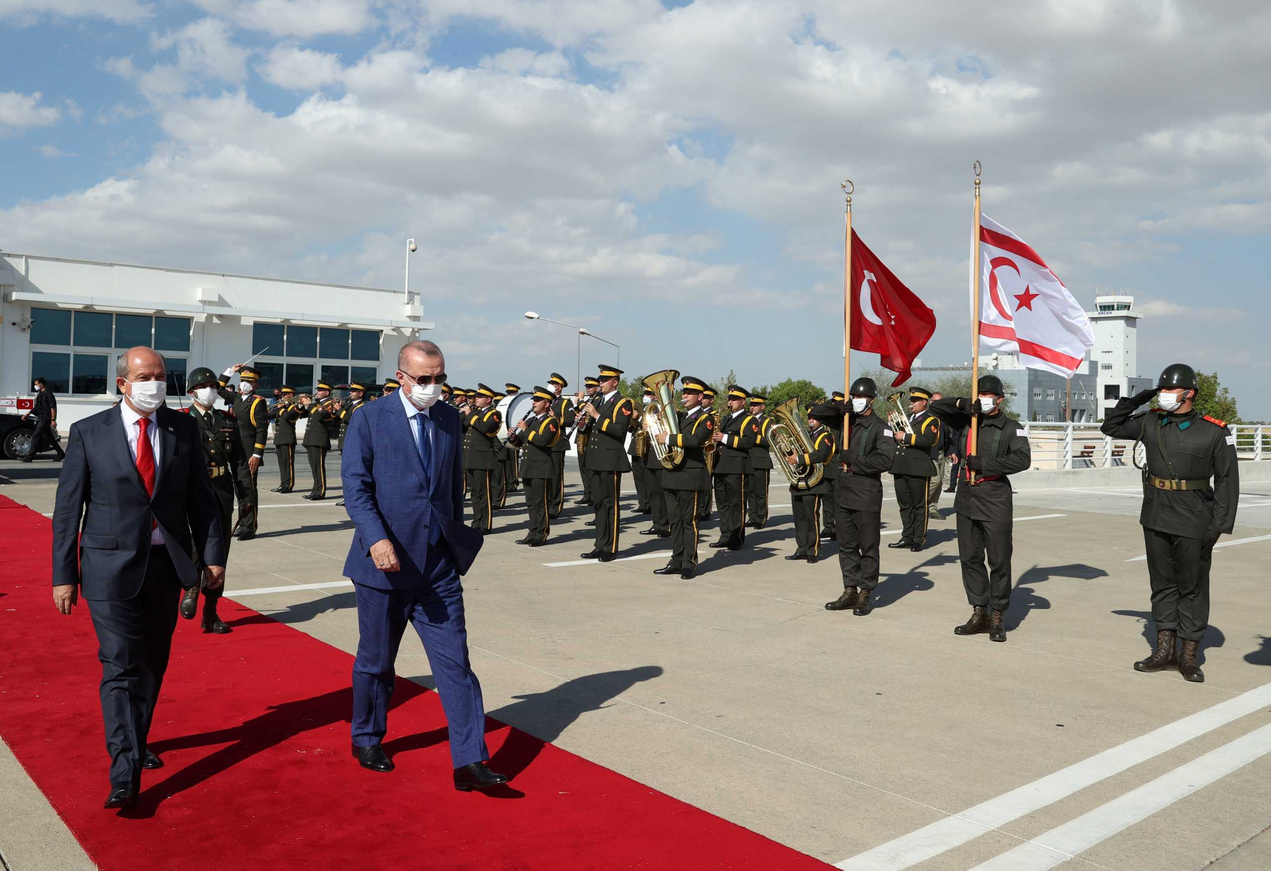 Turkish President Tayyip Erdogan reviews a guard of honour with Turkish Cypriot leader Ersin Tatar before he daparts from the Turkish Republic of Northern Cyprus, a breakway state recognized only by Turkey, in northern Nicosia, Cyprus July 20, 2021. Murat Cetinmuhurdar