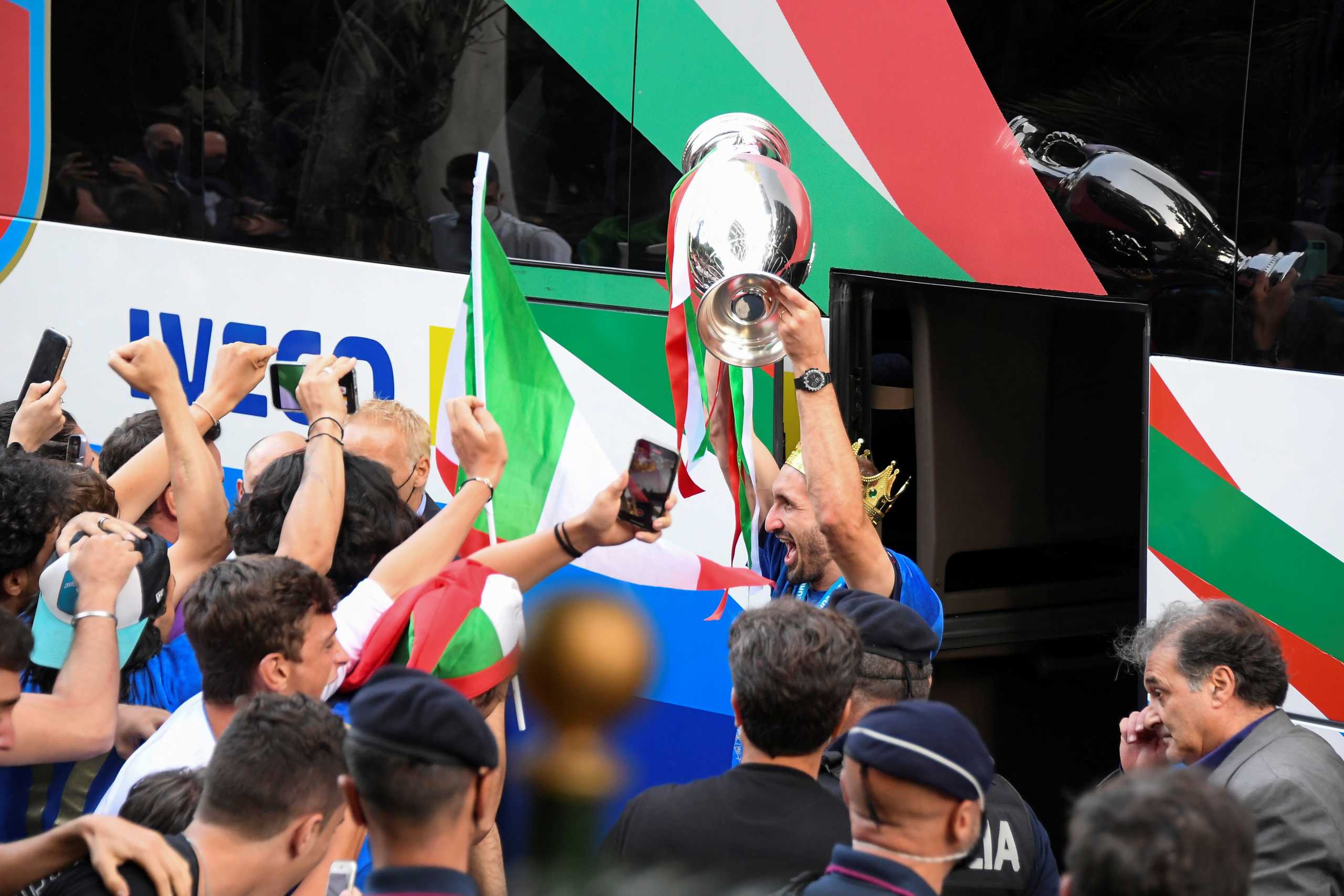 Soccer Football - Euro 2020 -  Rome, Italy - July 12, 2021 - Italy's Giorgio Chiellini exits the bus holding the Euro 2020 cup as the team arrives at the Parco dei Principi hotel after winning the European Championship. REUTERS