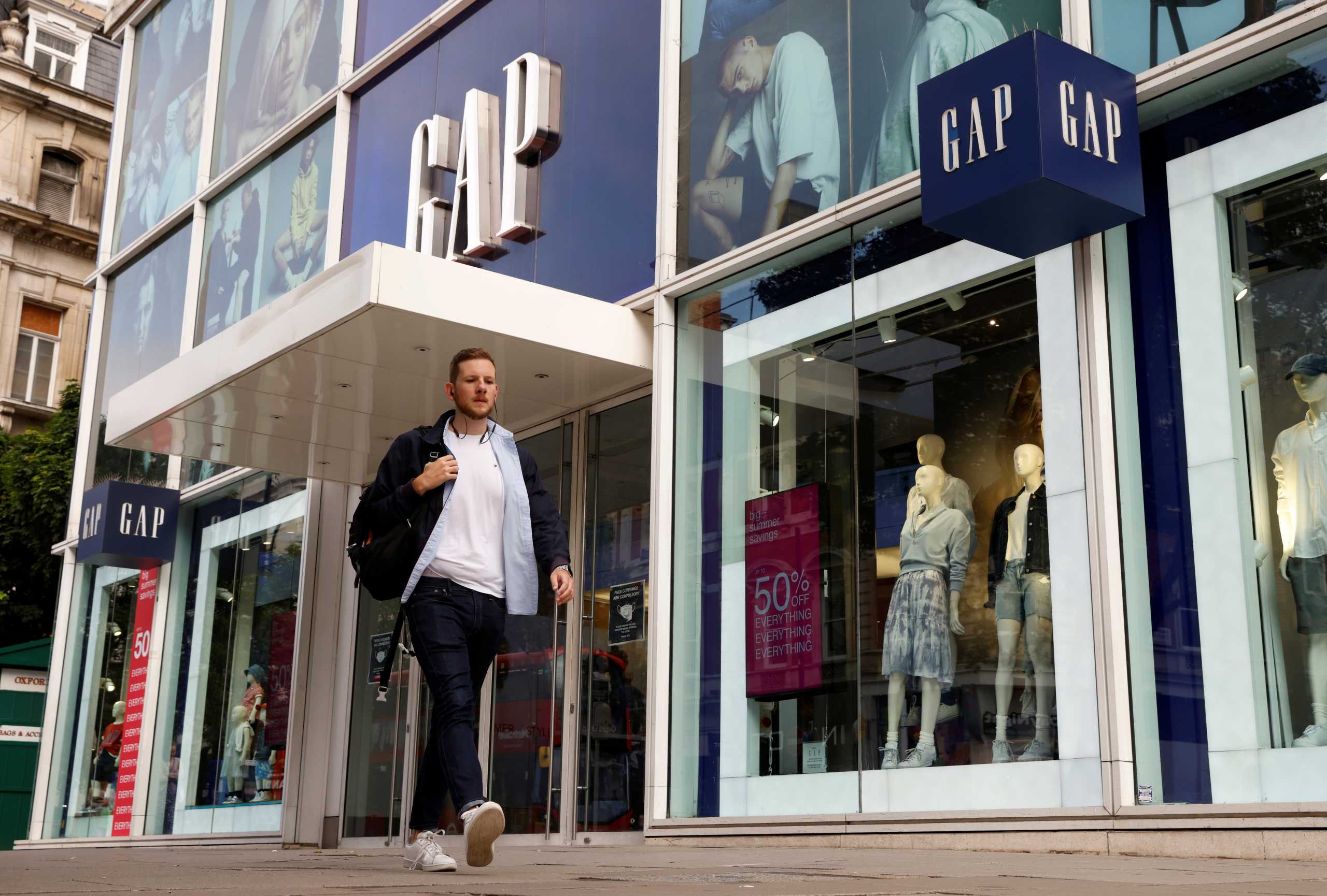 A man walks past a Gap store on Oxford Street in London, Britain, July 1, 2021. REUTERS