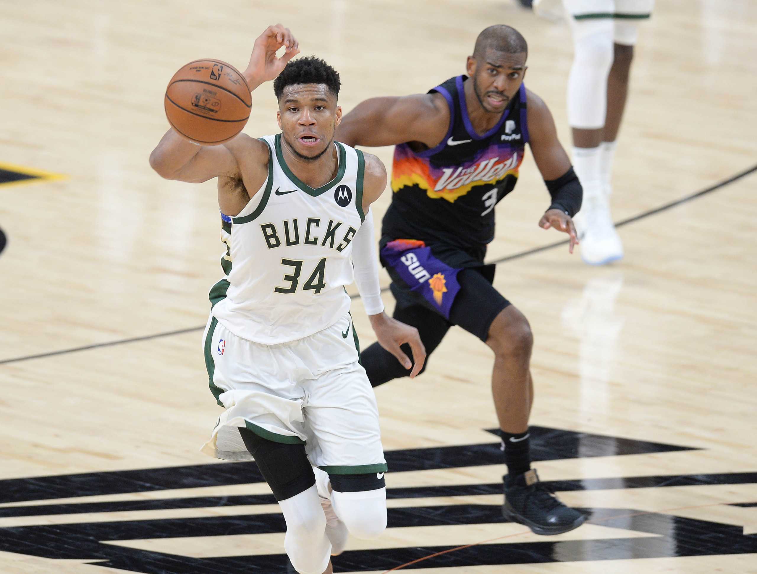 Jul 8, 2021; Phoenix, Arizona, USA; Milwaukee Bucks forward Giannis Antetokounmpo (34) plays for the ball against Phoenix Suns guard Chris Paul (3) during the second half in game two of the 2021 NBA Finals at Phoenix Suns Arena. Mandatory Credit: Joe Camporeale-USA TODAY Sports