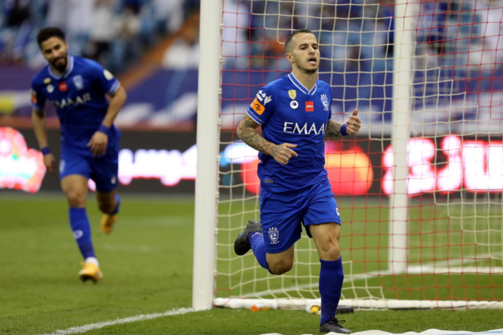 epa09237891 Al-Hilal's player Sebastian Giovinco (R) celebrates after scoring a goal during the Saudi Professional League soccer match between Al-Hilal and Al-Faisaly ​at ​King Fahd International Stadium, in Riyadh, Saudi Arabia, 30 May 2021.  EPA