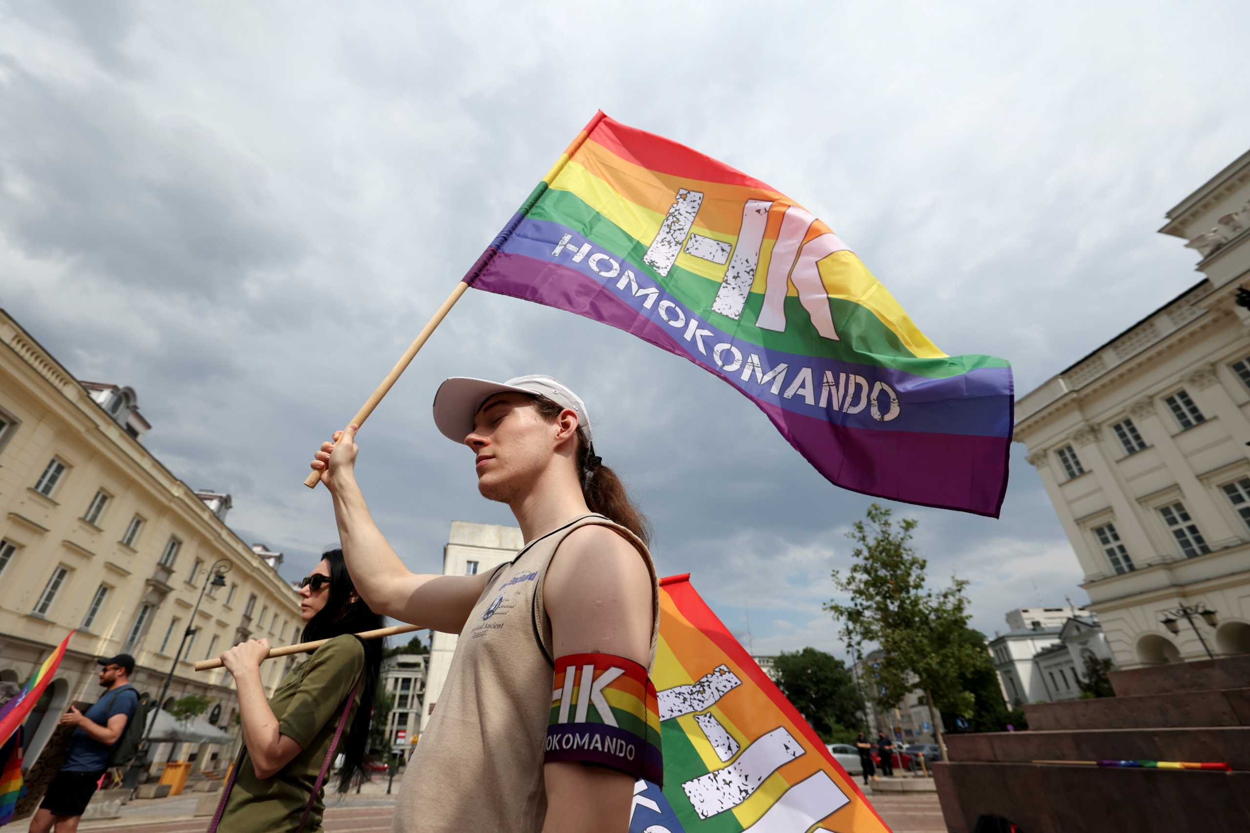 FILE PHOTO: Demonstrators holding flags attend a gathering in support of the LGBT community, in Warsaw, Poland June 26, 2021. Kuba Atys