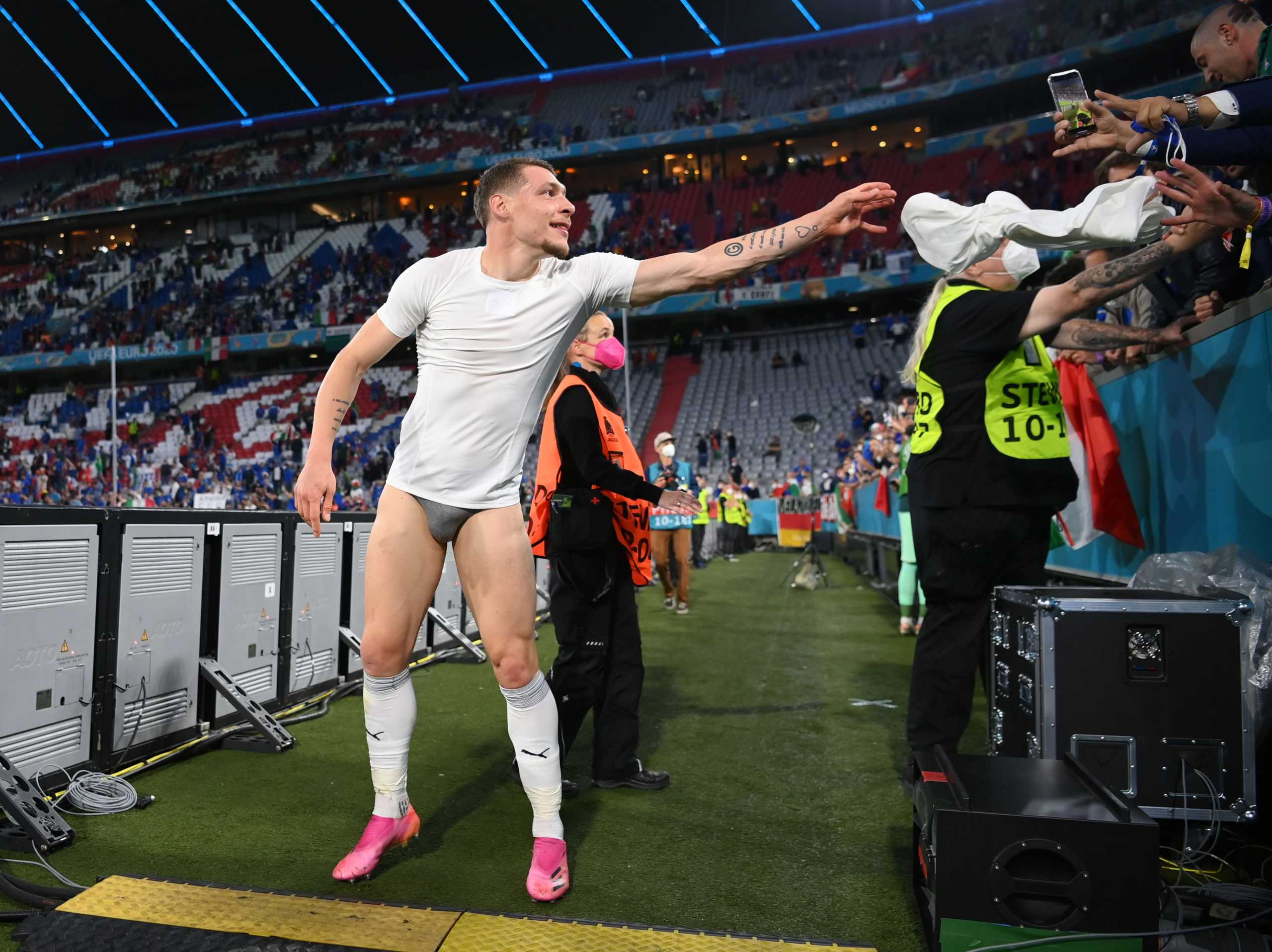 Soccer Football - Euro 2020 - Quarter Final - Belgium v Italy - Football Arena Munich, Munich, Germany - July 2, 2021 Italy's Andrea Belotti gives his shorts to a fan after the match Pool via REUTERS