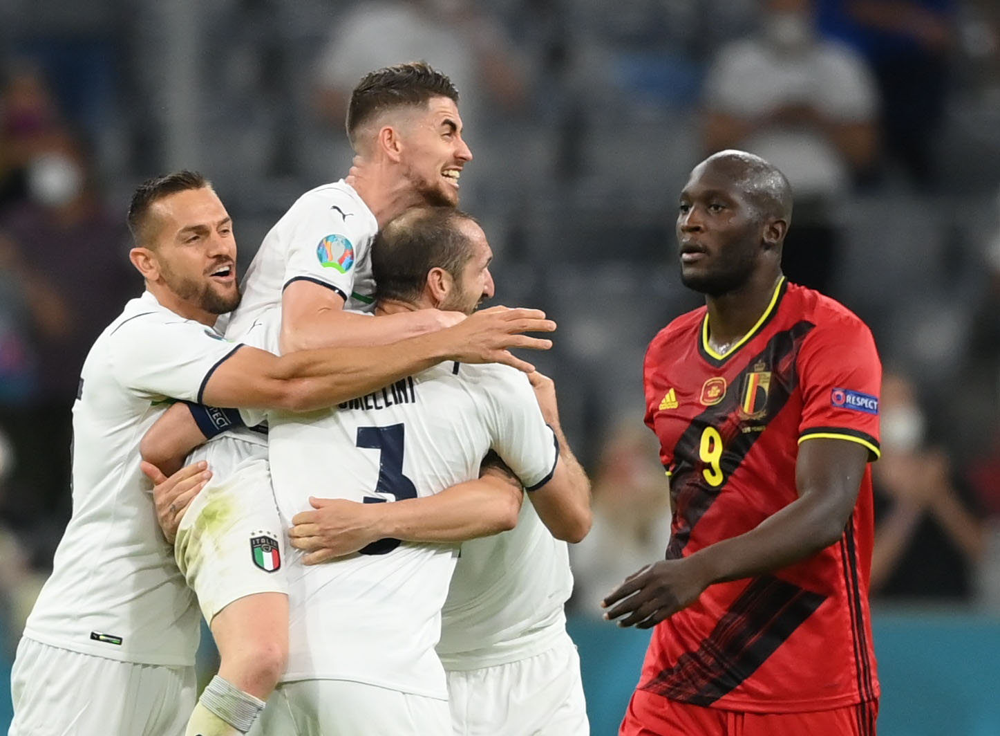 Soccer Football - Euro 2020 - Quarter Final - Belgium v Italy - Football Arena Munich, Munich, Germany - July 2, 2021 Italy players celebrate after the match as Belgium's Romelu Lukaku looks dejected Pool via REUTERS