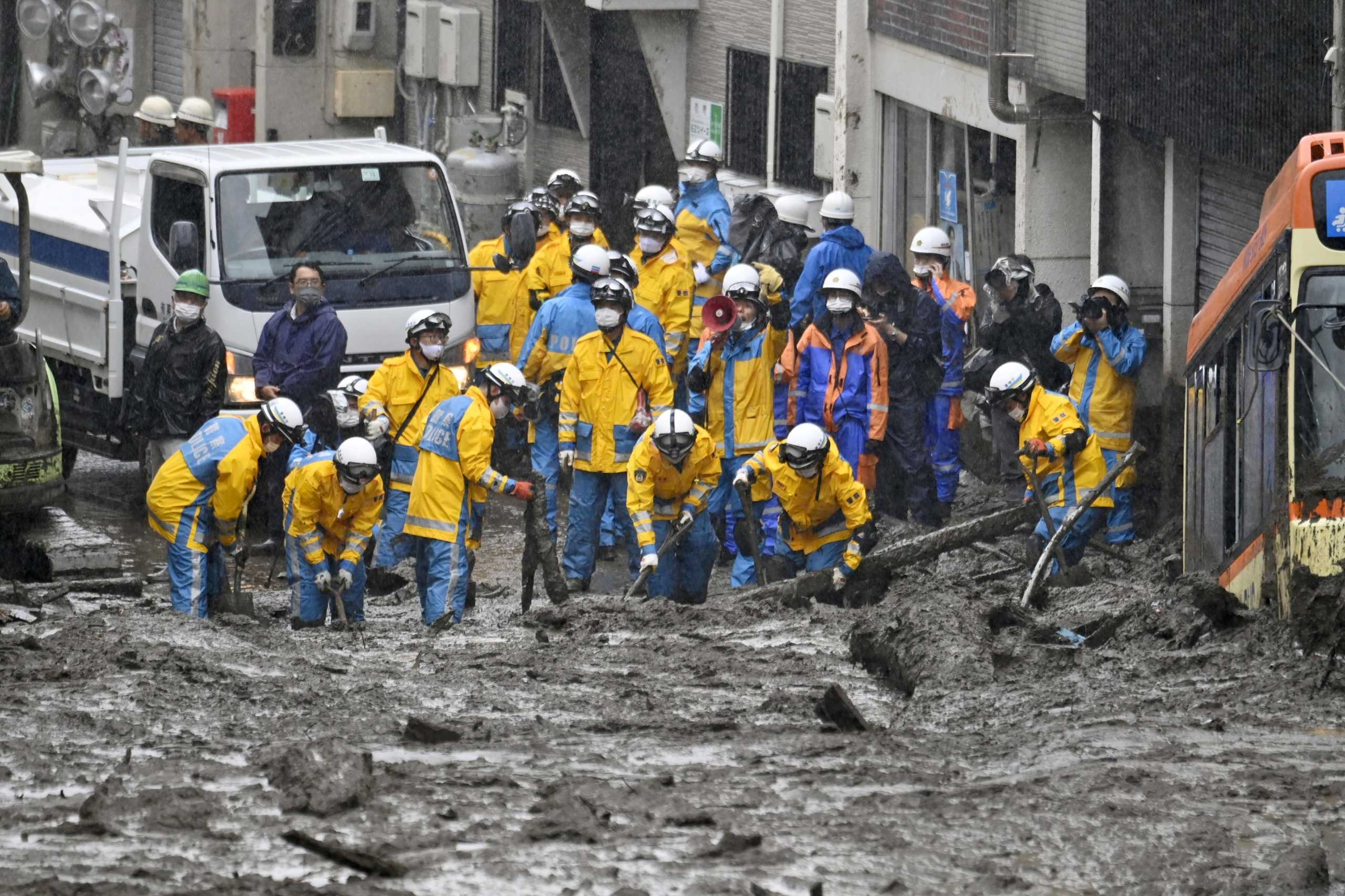 Police officers conduct search and rescue operation at a mudslide site caused by heavy rain at Izusan district in Atami, west of Tokyo, Japan July 4, 2021, in this photo taken by Kyodo. Kyodo