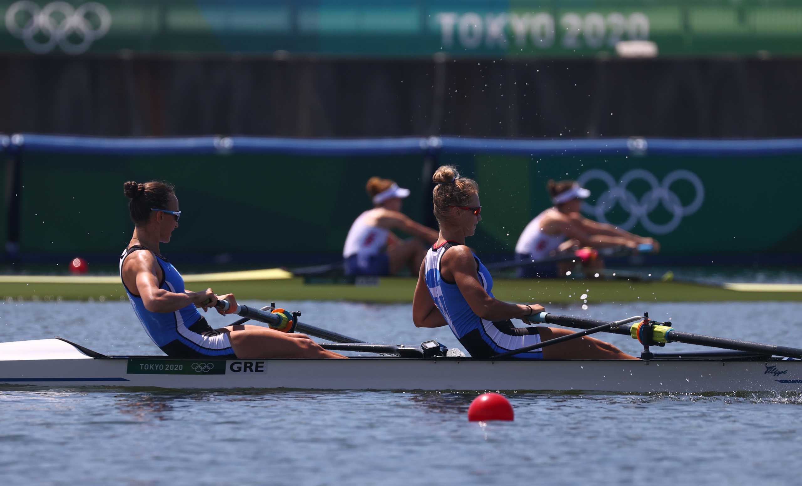 Tokyo 2020 Olympics - Rowing - Women's Pair - Repechage Round - Sea Forest Waterway, Tokyo, Japan - July 25, 2021. Maria Kyridou of Greece and Christina Bourmpou of Greece in action with Megan Kalmoe of the United States and Tracy Eisser of the United States